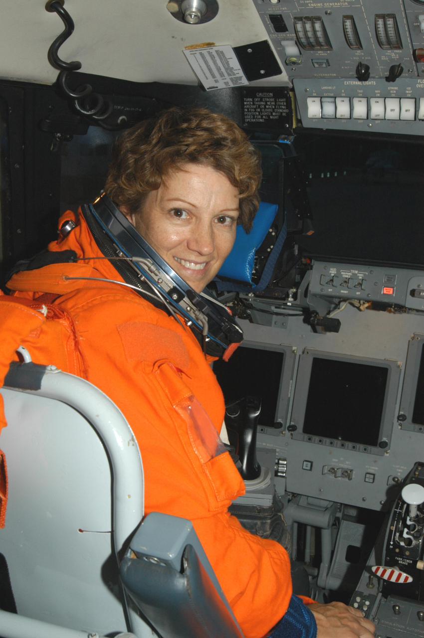 KENNEDY SPACE CENTER, FLA. - At the Shuttle Landing Facility on NASA Kennedy Space Center, STS-114 Mission Commander Eileen Collins sits in the cockpit of the Shuttle Training Aircraft (STA) after landing.  She and Pilot James Kelly have been practicing night landings in preparation for the mission.   The STA  is a modified Grumman American Aviation-built Gulf Stream II executive jet that was modified to simulate an orbiter’s cockpit, motion and visual cues, and handling qualities. In flight, the STA duplicates the orbiter’s atmospheric descent trajectory from approximately 35,000 feet altitude to landing on a runway. Because the orbiter is unpowered during re-entry and landing, its high-speed glide must be perfectly executed the first time.  Return to Flight Mission STS-114 is scheduled to launch aboard Space Shuttle Discovery with a crew of seven at 10:39 a.m. EDT on July 26.  Landing is expected on Aug. 7.