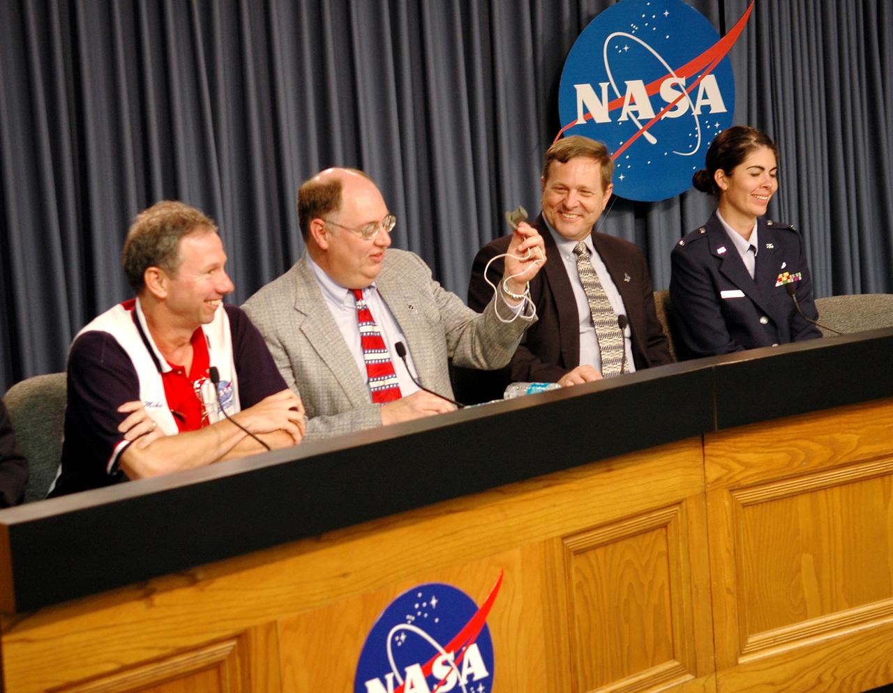 KENNEDY SPACE CENTER, FLA. - At the STS-114 Launch Readiness Press Conference at NASA Kennedy Space Center, the plan to launch July 26 is confirmed.  Seated from left are NASA Administrator Mike Griffin, Space Shuttle Deputy Program Manager Wayne Hale, Shuttle Processing Director Mike Wetmore and launch weather officer 1st Lt. Mindy Chavez, with the U.S. Air Force 45th Weather Squadron.  Hale is holding an ECO (engine cut-off) sensor similar to the one in Space Shuttle Discovery’s External Tank that had a faulty reading in the first launch attempt.  Liftoff of Space Shuttle Discovery on the Return to Flight mission STS-114 is scheduled for 10:39 a.m. EDT July 26 from Launch Pad 39B.