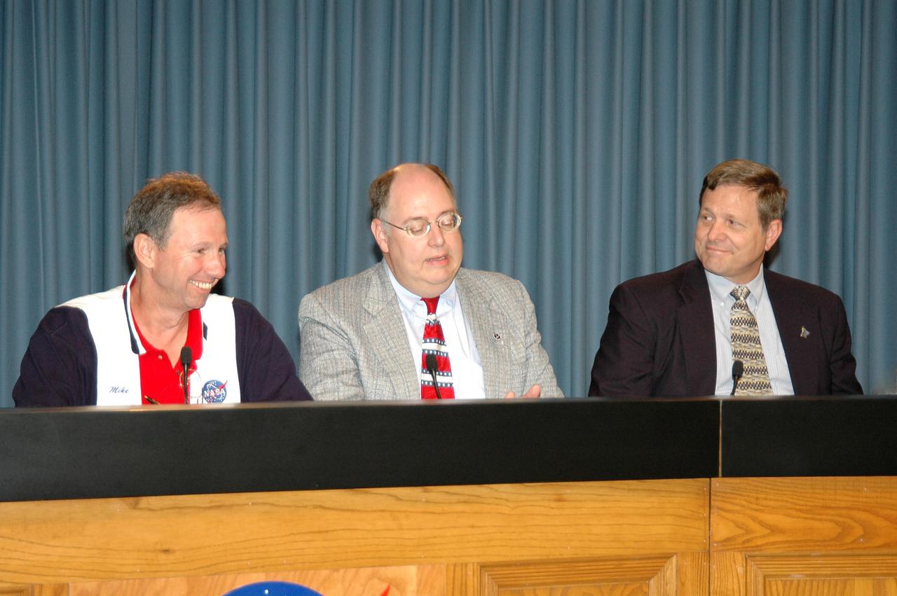 KENNEDY SPACE CENTER, FLA. - At the STS-114 Launch Readiness Press Conference at NASA Kennedy Space Center, Space Shuttle Deputy Program Manager Wayne Hale (center) answers a question from the media.  At the conference, NASA officials confirmed the July 26 launch.  Others seated with Hale on the stage are NASA Administrator Mike Griffin (left) and Shuttle Processing Director Mike Wetmore (right).  Not pictured is launch weather officer 1st Lt. Mindy Chavez, with the U.S. Air Force 45th Weather Squadron.  Liftoff of Space Shuttle Discovery on the Return to Flight mission STS-114 is scheduled for 10:39 a.m. EDT July 26 from Launch Pad 39B.