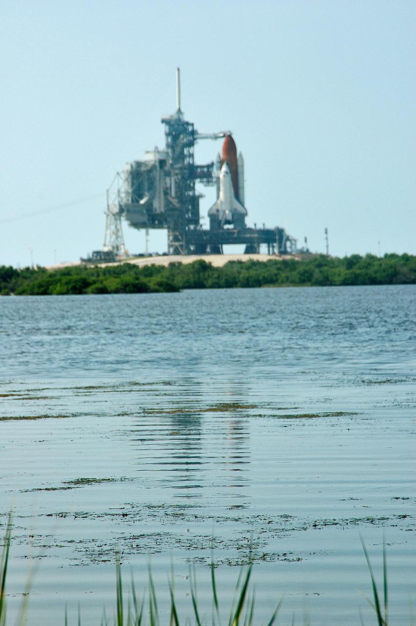 KENNEDY SPACE CENTER, FLA. - A pristine view to Launch Pad 39B at NASA Kennedy Space Center shows the Space Shuttle Discovery as it waits for launch. Discovery is scheduled to lift off on the historic Return to Flight mission STS-114 at 10:39 a.m. EDT July 26 with a crew of seven. On the mission to the International Space Station the crew will perform inspections on orbit for the first time of all of the Reinforced Carbon-Carbon (RCC) panels on the leading edge of the wings and the Thermal Protection System tiles using the new Canadian-built Orbiter Boom Sensor System and the data from 176 impact and temperature sensors. Mission Specialists will also practice repair techniques on RCC and tile samples during a spacewalk in the payload bay. During two additional spacewalks, the crew will install the External Stowage Platform-2, equipped with spare part assemblies, and a replacement Control Moment Gyroscope contained in the Lightweight Multi-Purpose Experiment Support Structure.