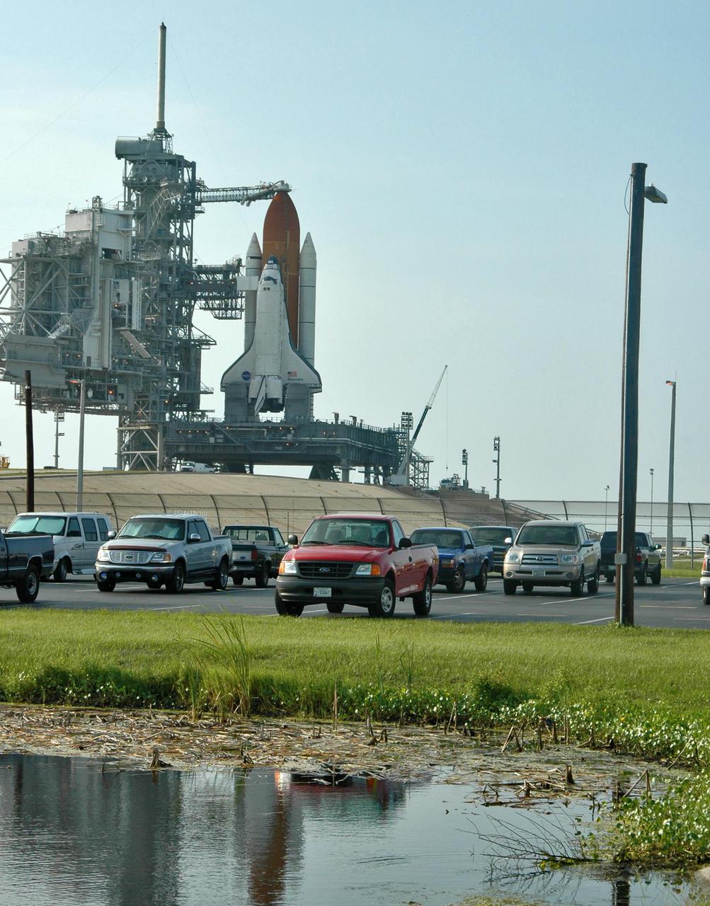 KENNEDY SPACE CENTER, FLA. -  Space Shuttle Discovery in full launch configuration is revealed after the Rotating Service Structure (RSS) was rotated back at Launch Pad 39B at NASA Kennedy Space Center. Rollback of the RSS is a major preflight milestone, typically occurring during the T-11-hour hold on L-1 (the day before launch). Discovery is scheduled to lift off on the historic Return to Flight mission STS-114 at 10:39 a.m. EDT July 26 with a crew of seven.