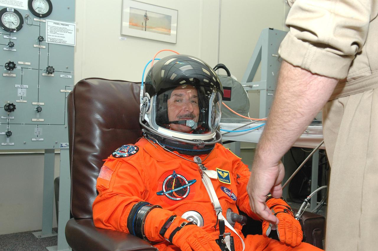 KENNEDY SPACE CENTER, FLA. -  In the Operations and Checkout Building at NASA Kennedy Space Center, STS-114 Mission Specialist Charles Camarda dons his launch and entry suit before heading to the launch pad.  Camarda is making his first space flight on the historic Return to Flight mission STS-114 to the International Space Station. On its second attempt for launch, Discovery is scheduled to lift off at 10:39 a.m. EDT today from Launch Pad 39B.  It is the 114th Space Shuttle flight and the 31st for Discovery.  The 12-day mission is expected to end with touchdown at the Shuttle Landing Facility on Aug. 7.