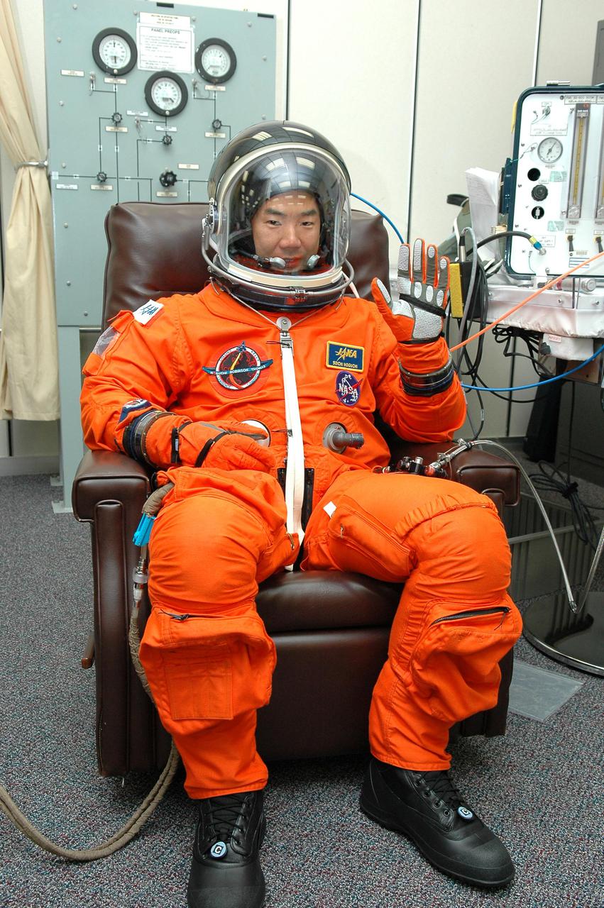 KENNEDY SPACE CENTER, FLA. -  In the Operations and Checkout Building at NASA Kennedy Space Center, STS-114 Mission Specialist Soichi Noguchi has donned his launch and entry suit before heading to the launch pad.  Noguchi is with the Japan Aerospace Exploration Agency and is making his first space flight on the historic Return to Flight mission STS-114 to the International Space Station.  On its second attempt for launch, Discovery is scheduled to lift off at 10:39 a.m. EDT today from Launch Pad 39B.  It is the 114th Space Shuttle flight and the 31st for Discovery.  The 12-day mission is expected to end with touchdown at the Shuttle Landing Facility on Aug. 7.