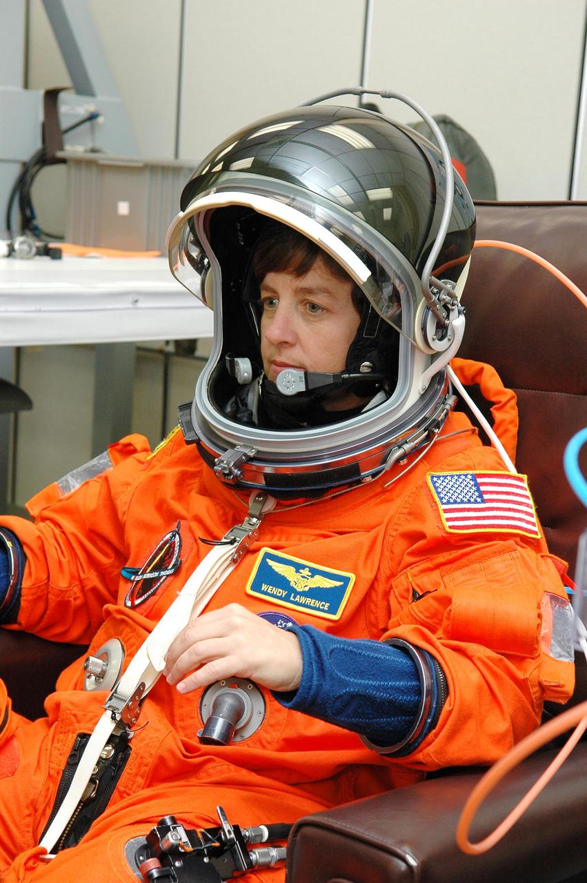 KENNEDY SPACE CENTER, FLA. -  In the Operations and Checkout Building at NASA Kennedy Space Center, STS-114 Mission Specialist Wendy Lawrence dons her launch and entry suit before heading to the launch pad.  Lawrence is making her fourth space flight on the historic Return to Flight mission STS-114 to the International Space Station.  On its second attempt for launch, Discovery is scheduled to lift off at 10:39 a.m. EDT today from Launch Pad 39B.  It is the 114th Space Shuttle flight and the 31st for Discovery.  The 12-day mission is expected to end with touchdown at the Shuttle Landing Facility on Aug. 7.
