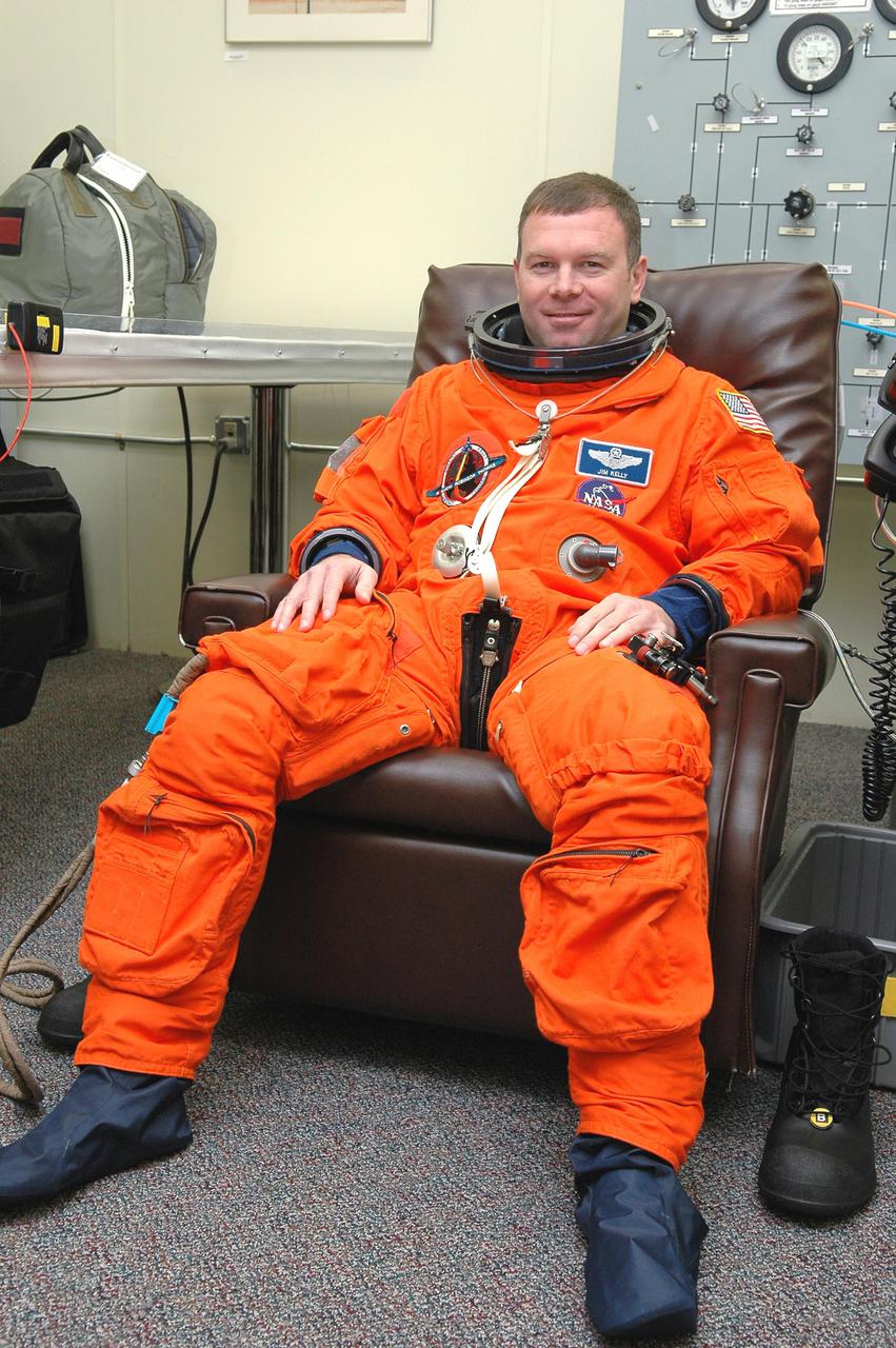 KENNEDY SPACE CENTER, FLA. -  In the Operations and Checkout Building at NASA Kennedy Space Center, STS-114 Pilot James Kelly is donning his launch and entry suit before heading to the launch pad.  Kelly is making his second space flight on the historic Return to Flight mission STS-114 to the International Space Station.  On its second attempt for launch, Discovery is scheduled to lift off at 10:39 a.m. EDT today from Launch Pad 39B.  It is the 114th Space Shuttle flight and the 31st for Discovery.  The 12-day mission is expected to end with touchdown at the Shuttle Landing Facility on Aug. 7.