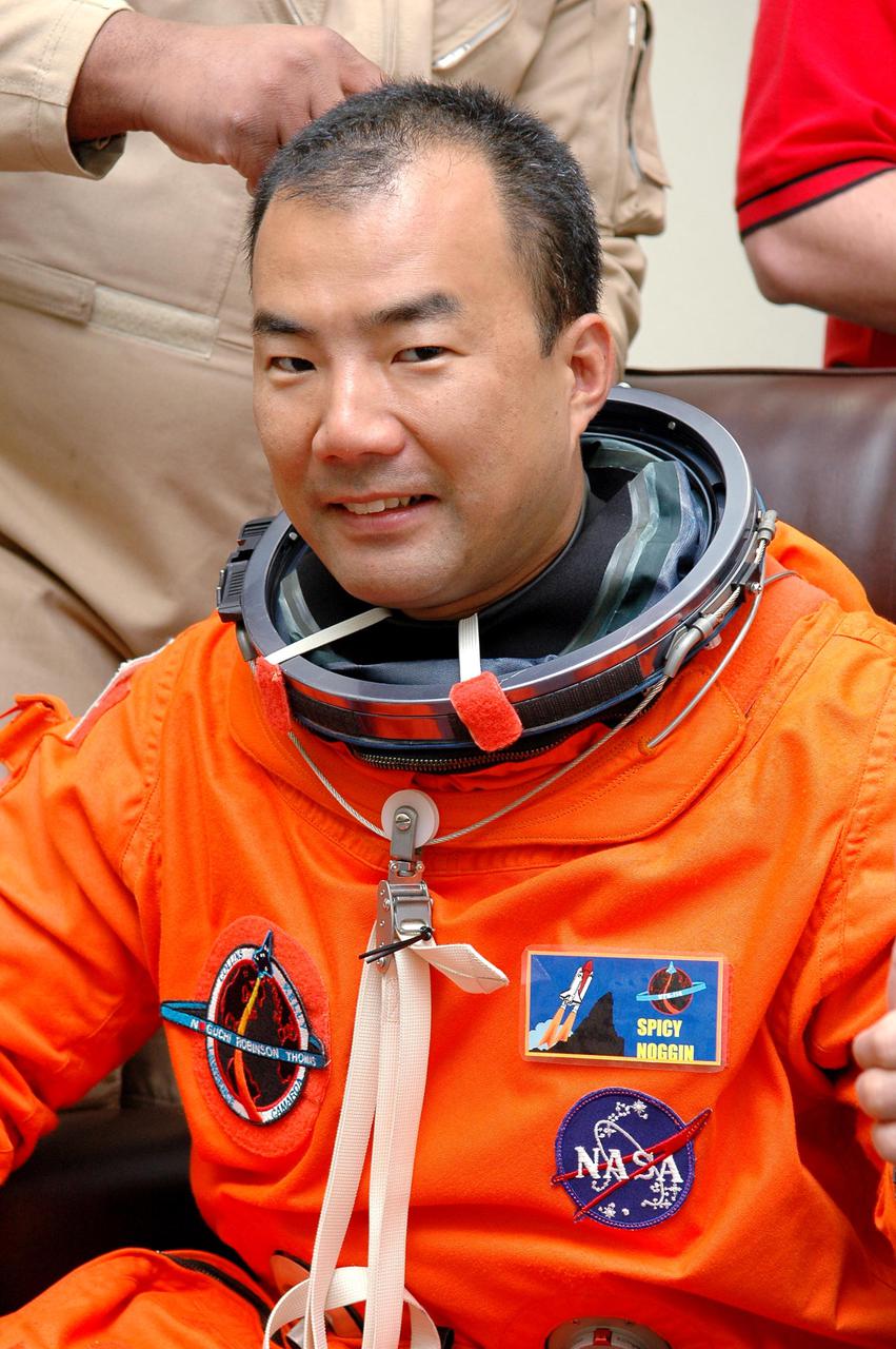 KENNEDY SPACE CENTER, FLA. -  In the Operations and Checkout Building at NASA Kennedy Space Center, STS-114 Mission Specialist Soichi Noguchi eagerly anticipates his first space flight as he dons his launch and entry suit for  the historic Return to Flight mission STS-114 to the International Space Station. On its second attempt for launch, Discovery is scheduled to lift off at 10:39 a.m. EDT today from Launch Pad 39B.  It is the 114th Space Shuttle flight and the 31st for Discovery.  The 12-day mission is expected to end with touchdown at the Shuttle Landing Facility on Aug. 7.