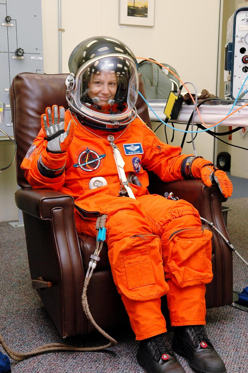 KENNEDY SPACE CENTER, FLA. -   In the Operations and Checkout Building at NASA Kennedy Space Center, STS-114 Mission Commander Eileen Collins dons the helmet of her launch and entry suit before heading to the launch pad.  Collins is making her fourth space flight on the historic Return to Flight mission STS-114 to the International Space Station.  On its second attempt for launch, Discovery is scheduled to lift off at 10:39 a.m. EDT today from Launch Pad 39B.  It is the 114th Space Shuttle flight and the 31st for Discovery.  The 12-day mission is expected to end with touchdown at the Shuttle Landing Facility on Aug. 7.