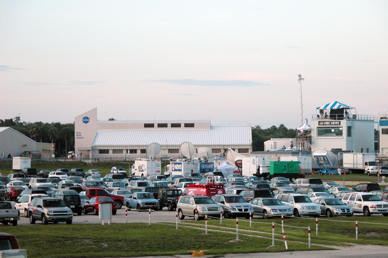 KENNEDY SPACE CENTER, FLA. - The parking lot at the NASA News Center overflows with cars and satellite trucks for the media who hoped to capture the images of Space Shuttle Discovery landing at KSC. Due to weather concerns, the landing was deferred to Edwards Air Force Base in California. The 13-day, 21-hour Return to Flight STS-114 mission ended on Runway 22 at 8:11:22 a.m. EDT with Mission Commander Eileen Collins on the controls. Discovery spent two weeks in space, where the crew demonstrated new methods to inspect and repair the Shuttle in orbit. The crew also delivered supplies, outfitted and performed maintenance on the International Space Station. A number of these tasks were conducted during three spacewalks. Photo credit: NASA_Debbie Kiger