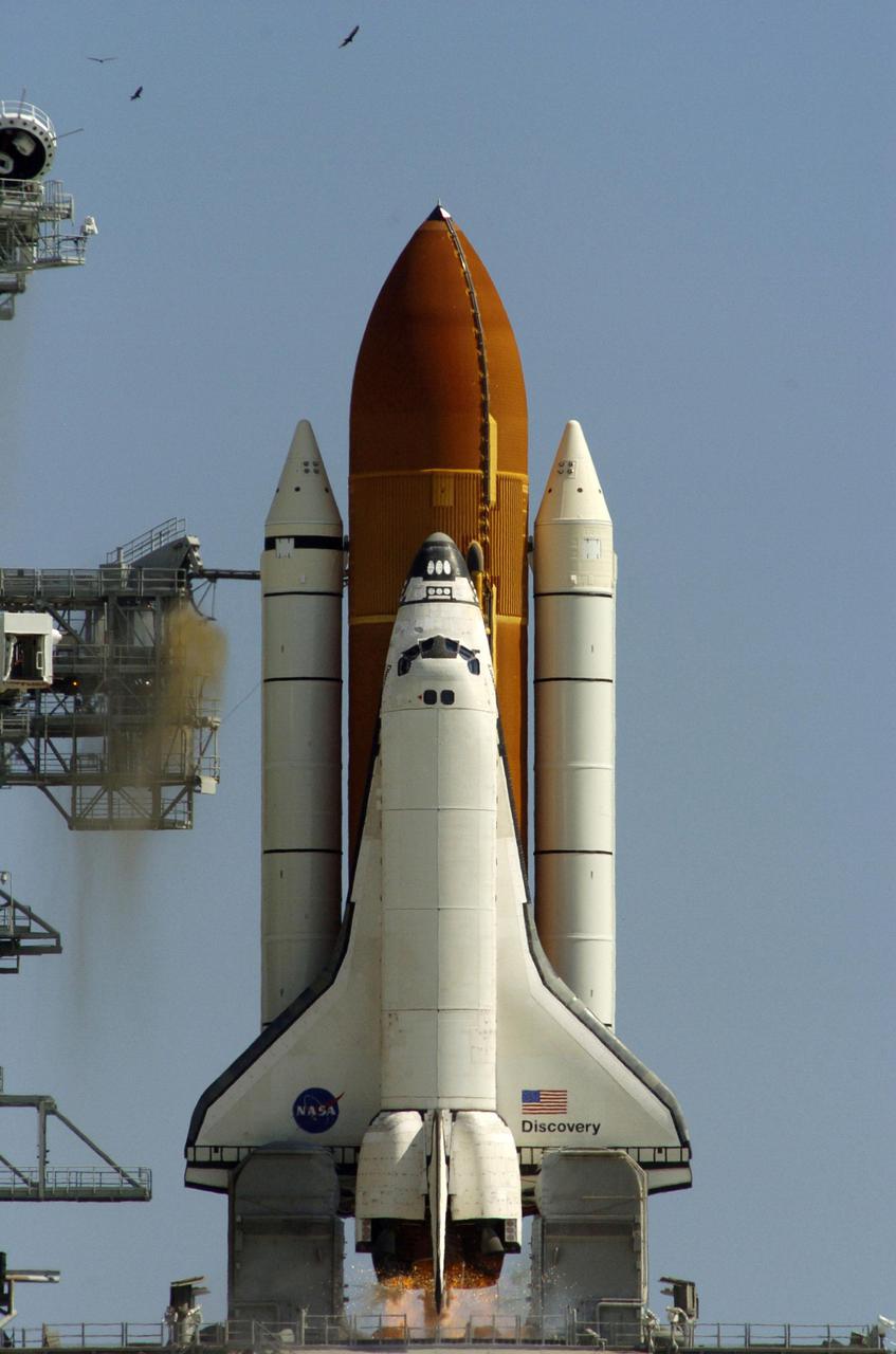 KENNEDY SPACE CENTER, FLA. - On Launch Pad 39B at NASA Kennedy Space Center, Space Shuttle Discovery fires its engines for liftoff on Return to Flight mission STS-114 to the International Space Station. Liftoff was at 10:39 EDT. It is the 114th flight in the Space Shuttle Program and the 31st for Discovery. The 12-day mission is expected to end with touchdown at the Shuttle Landing Facility on Aug. 7. On this mission to the International Space Station the crew will perform inspections on-orbit for the first time of all of the Reinforced Carbon-Carbon (RCC) panels on the leading edge of the wings and the Thermal Protection System tiles using the new Canadian-built Orbiter Boom Sensor System and the data from 176 impact and temperature sensors. Mission Specialists will also practice repair techniques on RCC and tile samples during a spacewalk in the payload bay. During two additional spacewalks, the crew will install the External Stowage Platform-2, equipped with spare part assemblies, and a replacement Control Moment Gyroscope contained in the Lightweight Multi-Purpose Experiment Support Structure. (Photo Credit: Scott Andrews)