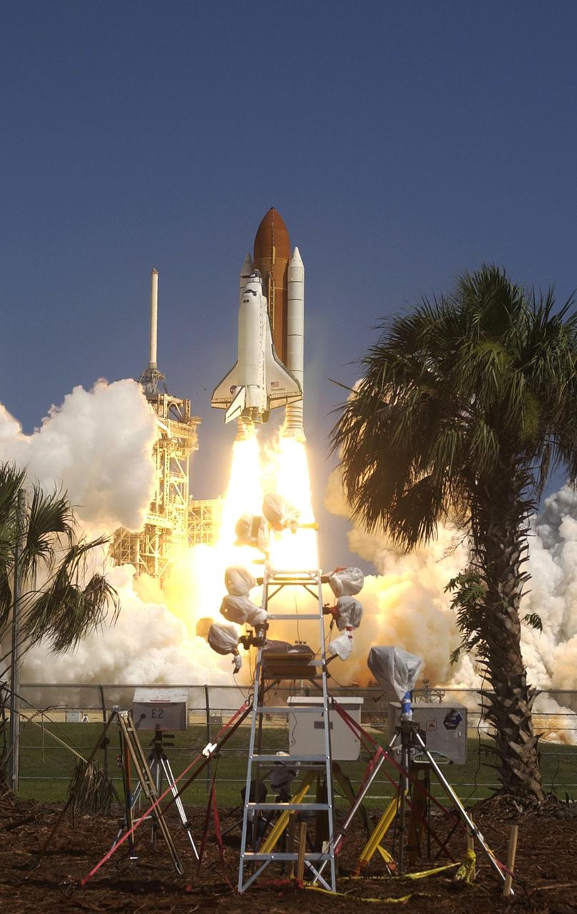 KENNEDY SPACE CENTER, FLA. - Multiple cameras on the perimeter of Launch Pad 39B capture the launch of Space Shuttle Discovery as it rises above the lightning mast (left side) on the historic Return to Flight mission STS-114. It is the 114th flight in the Space Shuttle Program and the 31st for Discovery. The 12-day mission is expected to end with touchdown at the Shuttle Landing Facility on Aug. 7. On this mission to the International Space Station the crew will perform inspections on-orbit for the first time of all of the Reinforced Carbon-Carbon (RCC) panels on the leading edge of the wings and the Thermal Protection System tiles using the new Canadian-built Orbiter Boom Sensor System and the data from 176 impact and temperature sensors. Mission Specialists will also practice repair techniques on RCC and tile samples during a spacewalk in the payload bay. During two additional spacewalks, the crew will install the External Stowage Platform-2, equipped with spare part assemblies, and a replacement Control Moment Gyroscope contained in the Lightweight Multi-Purpose Experiment Support Structure. (Photo Credit: Scott Andrews)