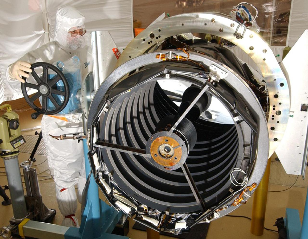 KENNEDY SPACE CENTER, FLA. - The High Resolution Imaging Science Experiment (HiRISE) camera is examined by a worker from Ball Aerospace and Technologies Corp. Scheduled to launch Aug. 10 aboard an Atlas V rocket from Launch Complex 41 at Cape Canaveral Air Force Station in Florida, HiRISE is designed to take high-resolution images of the surface of Mars from orbit provide unprecedented image quality, resolution and coverage at sub-meter scales. The MRO will search for evidence of water, study the climate record, and identify landing sites for future missions. The MRO is scheduled for launch aboard an Atlas V rocket from Launch Complex 41 at Cape Canaveral Air Force Station in Florida. The MRO is an important next step in fulfilling NASA’s vision of space exploration and ultimately sending human explorers to Mars and beyond.