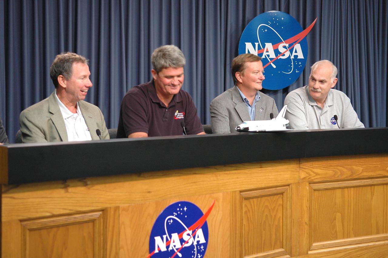 KENNEDY SPACE CENTER, FLA. -  At a post-landing briefing, mission management cannot help smiling over the good news that Space Shuttle Discovery safely landed at Edwards Air Force Base in California.  From left are NASA Administrator Mike Griffin, Space Shuttle Program Manager Bill Parsons, Shuttle Launch Director Mike Leinbach and Associate Administrator of NASA’s Space Operations Mission Directorate Bill Readdy.  A landing at Kennedy Space Center was deferred due to weather concerns.  The California landing occurred at 8:11 a.m. EDT, guided by Mission Commander Eileen Collins.  Discovery spent two weeks in space on Return to Flight mission STS-114, where the crew demonstrated new methods to inspect and repair the Shuttle in orbit. The crew also delivered supplies, outfitted and performed maintenance on the International Space Station. A number of these tasks were conducted during three spacewalks.