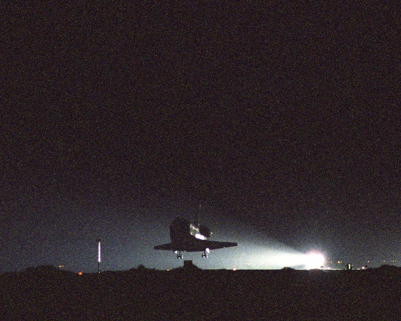 DRYDEN FLIGHT RESEARCH CENTER, CA. -   (EC05-0166-02_Dryden) Before dawn, Space Shuttle Discovery approaches Runway 22 at Edwards Air Force Base in California after completing the successful Return to Flight mission STS-114 to the International Space Station.  Landing time was 8:11:22 a.m. EDT.  The landing was deferred from Kennedy Space Center due to weather concerns.  Aboard Discovery was her crew of seven: Mission Commander Eileen Collins, Pilot James Kelly and Mission Specialists Stephen Robinson, Andrew Thomas, Wendy Lawrence, Charles Camarda and Soichi Noguchi, who represents the Japan Aerospace Exploration Agency.  This is the 50th Shuttle landing at Edwards and the sixth night landing.