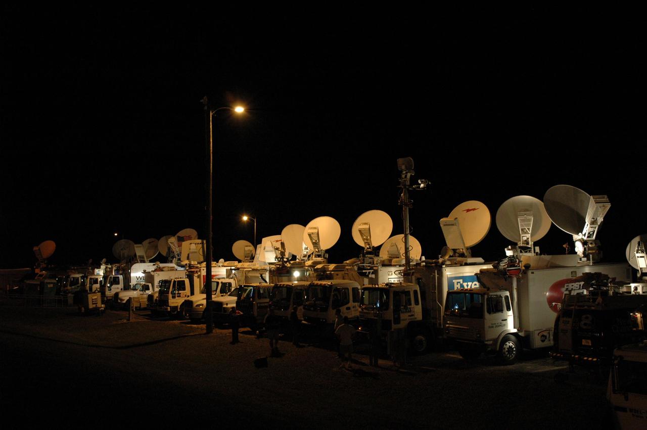 KENNEDY SPACE CENTER, FLA. - Satellite trucks are lined up alongside Runway 33 at NASA Kennedy Space Center’s Shuttle Landing Facility to wait for the early morning landing of Space Shuttle Discovery, returning from the successful Return to Flight mission STS-114. The landing was eventually deferred to Edwards Air Force Base in California due to weather concerns. The landing occurred at 8:11 a.m. EDT, guided by Mission Commander Eileen Collins. Discovery spent two weeks in space on Return to Flight mission STS-114, where the crew demonstrated new methods to inspect and repair the Shuttle in orbit. The crew also delivered supplies, outfitted and performed maintenance on the International Space Station. A number of these tasks were conducted during three spacewalks.