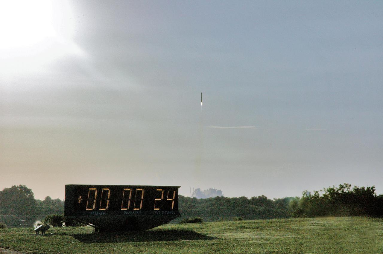 KENNEDY SPACE CENTER, FLA. - Viewed from the NASA News Center, the Mars Reconnaissance Orbiter (MRO) atop a Lockheed Martin Atlas V rocket streaks through the morning sky. The MRO launched at 7:43 a.m. EDT from Launch Complex 41 at Cape Canaveral Air Force Station in Florida. All systems performed nominally for NASA's first Atlas V launch. The spacecraft will arrive at Mars in March 2006. Once in orbit around Mars, various instruments on the MRO will convey detailed observations of the Martian surface, subsurface and atmosphere. Researchers will use the data to study the history and distribution of Martian water. Learning more about what has happened to the water will focus searches for possible past or present Martian life. Observations by the orbiter will also support future Mars missions by examining potential landing sites and providing a communications relay between the Martian surface and Earth.