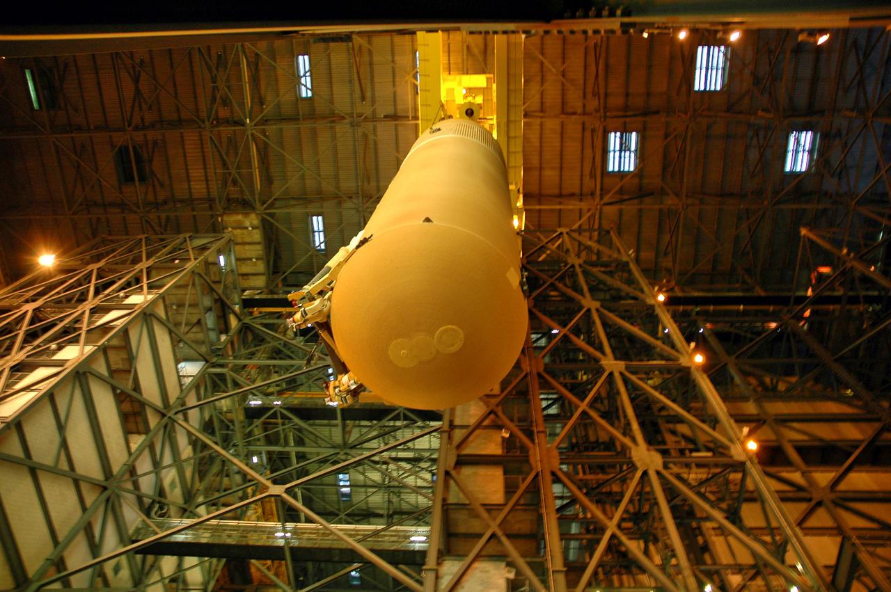 KENNEDY SPACE CENTER, FLA. - External Tank 119 is being lowered to the transfer aisle in the Vehicle Assembly Building.  There it will be lowered and placed on the transporter to be moved to the barge at the Turn Basin.  The tank will embark on a voyage around the Florida peninsula  to the Michoud Assembly Facility in New Orleans.  Delivered to KSC in June, ET-119 is the third newly redesigned tank.