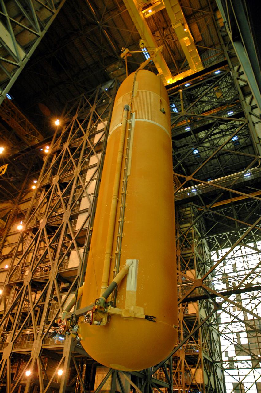KENNEDY SPACE CENTER, FLA.  - External Tank 119 is being lowered to the transfer aisle in the Vehicle Assembly Building.  There it will be lowered and placed on the transporter to be moved to the barge at the Turn Basin.  The tank will embark on a voyage around the Florida peninsula  to the Michoud Assembly Facility in New Orleans.  Delivered to KSC in June, ET-119 is the third newly redesigned tank.