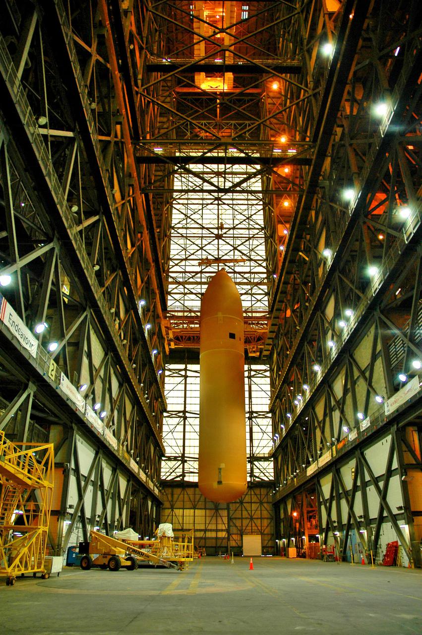 KENNEDY SPACE CENTER, FLA.  - External Tank 119 is lowered to the transfer aisle in the Vehicle Assembly Building.  There it will be lowered and placed on the transporter to be moved to the barge at the Turn Basin.  The tank will embark on a voyage around the Florida peninsula  to the Michoud Assembly Facility in New Orleans.  Delivered to KSC in June, ET-119 is the third newly redesigned tank.
