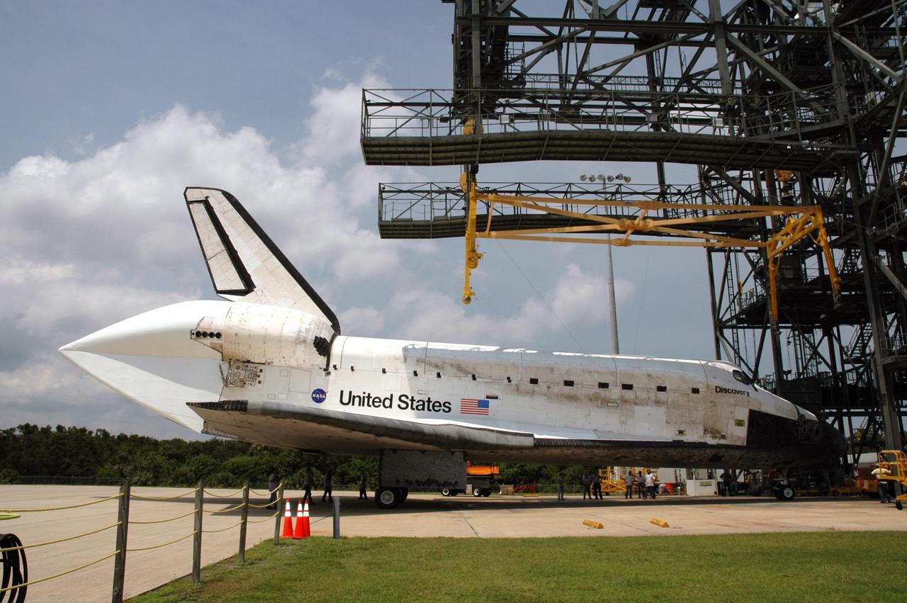 KENNEDY SPACE CENTER, FLA. - Discovery begins rolling away from the mate_demate device on NASA Kennedy Space Center’s Shuttle Landing Facility. The equipment that lowered it to the ground has been removed. Discovery was returned to NASA Kennedy Space Center on a ferry flight atop the Shuttle Carrier Aircraft from Edwards Air Force Base in California, arriving Aug. 21. Visible on Discovery is the tail cone that covers and protects the main engines during the ferry flight. Discovery will be towed to the Orbiter Processing Facility where the Multi-Purpose Logistics Module Raffaello still inside will be removed from the payload bay and transferred to the Space Station Processing Facility. The orbiter will then begin processing for the second Return to Flight mission, STS-121, scheduled for launch no earlier than March 2006.