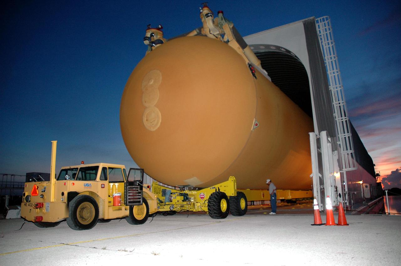 KENNEDY SPACE CENTER, FLA. - Under pre-dawn skies of blue and red, External Tank 119 is loaded onto the barge at the Turn Basin. The tank will embark on a voyage around the Florida peninsula to the Michoud Assembly Facility in New Orleans. Delivered to KSC in June, ET-119 is the third newly redesigned tank.