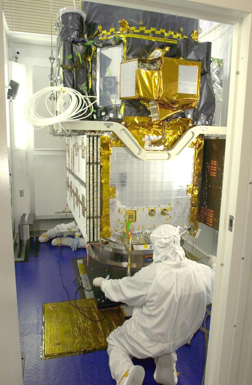VANDENBERG AIR FORCE BASE, CALIF. - At Vandenberg Air Force Base in California, workers help secure the CALIPSO spacecraft inside a specially modified container where LIDAR (LIght Detection And Ranging) laser testing will take place. CALIPSO stands for Cloud-Aerosol LIDAR and Infrared Pathfinder Satellite Observation. LIDAR measures distance, speed, rotation, chemical composition and concentration. CALIPSO and CloudSat will fly in formation with three other satellites in the A-train constellation to enhance understanding of our climate system. They are highly complementary satellites and together they will provide never-before-seen 3-D perspectives of how clouds and aerosols form, evolve, and affect weather and climate. Launch of CALIPSO_CloudSat aboard a Boeing Delta II rocket is scheduled for 3:01 a.m. PDT Sept. 29.