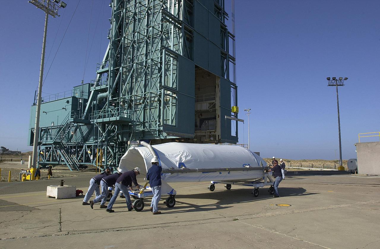 VANDENBERG AIR FORCE BASE, CALIF.  - One half of the fairing to cover CALIPSO_CloudSat arrives at NASA Space Launch Complex 2 on Vandenberg Air Force Base in California.  The fairing encloses and protects the spacecraft during launch and flight through the atmosphere. Once in space, it is jettisoned. CALIPSO stands for Cloud-Aerosol Lidar and Infrared Pathfinder Satellite Observation.   CALIPSO and CloudSat are highly complementary satellites and together will provide never-before-seen 3-D perspectives of how clouds and aerosols form, evolve, and affect weather and climate. CALIPSO and CloudSat will fly in formation with three other satellites in the A-train constellation to enhance understanding of our climate system. Launch of CALIPSO_CloudSat aboard a Boeing Delta II rocket is scheduled for 3:01 a.m. Sept. 29.