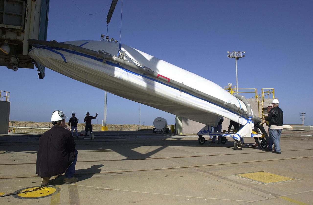 VANDENBERG AIR FORCE BASE, CALIF.  - At NASA Space Launch Complex 2 on Vandenberg Air Force Base in California, one half of the fairing for CALIPSO_CloudSat to cover CALIPSO_CloudSat is being raised to a vertical position. It will then be lifted into the mobile service tower, or gantry. The fairing encloses and protects the spacecraft during launch and flight through the atmosphere. Once in space, it is jettisoned. CALIPSO stands for Cloud-Aerosol Lidar and Infrared Pathfinder Satellite Observation.   CALIPSO and CloudSat are highly complementary satellites and together will provide never-before-seen 3-D perspectives of how clouds and aerosols form, evolve, and affect weather and climate. CALIPSO and CloudSat will fly in formation with three other satellites in the A-train constellation to enhance understanding of our climate system. Launch of CALIPSO_CloudSat aboard a Boeing Delta II rocket is scheduled for 3:01 a.m. Sept. 29.