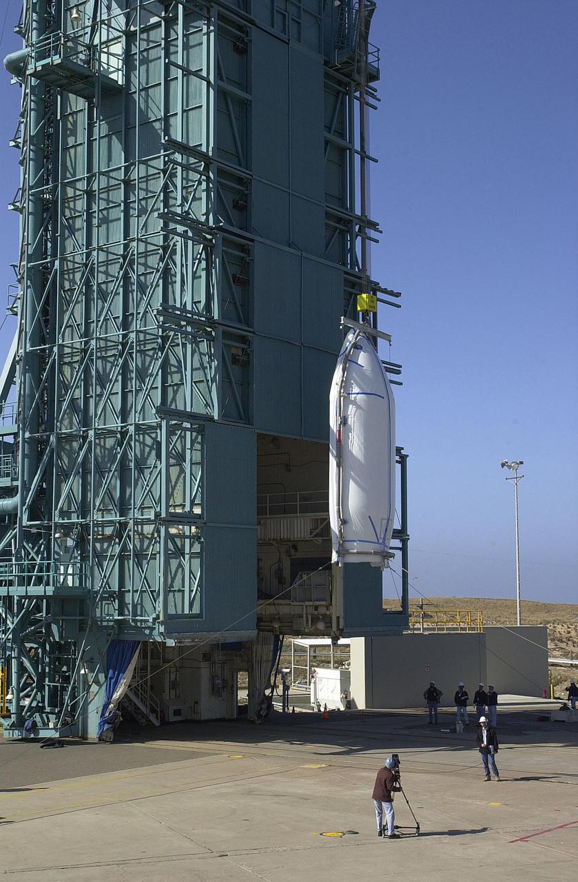 VANDENBERG AIR FORCE BASE, CALIF.   -  At NASA Space Launch Complex 2 on Vandenberg Air Force Base in California, one half of the fairing for CALIPSO_CloudSat begins the slow lift up the mobile service tower, or gantry.  The fairing encloses and protects the spacecraft during launch and flight through the atmosphere. Once in space, it is jettisoned. CALIPSO stands for Cloud-Aerosol Lidar and Infrared Pathfinder Satellite Observation.   CALIPSO and CloudSat are highly complementary satellites and together will provide never-before-seen 3-D perspectives of how clouds and aerosols form, evolve, and affect weather and climate. CALIPSO and CloudSat will fly in formation with three other satellites in the A-train constellation to enhance understanding of our climate system. Launch of CALIPSO_CloudSat aboard a Boeing Delta II rocket is scheduled for 3:01 a.m. Sept. 29.