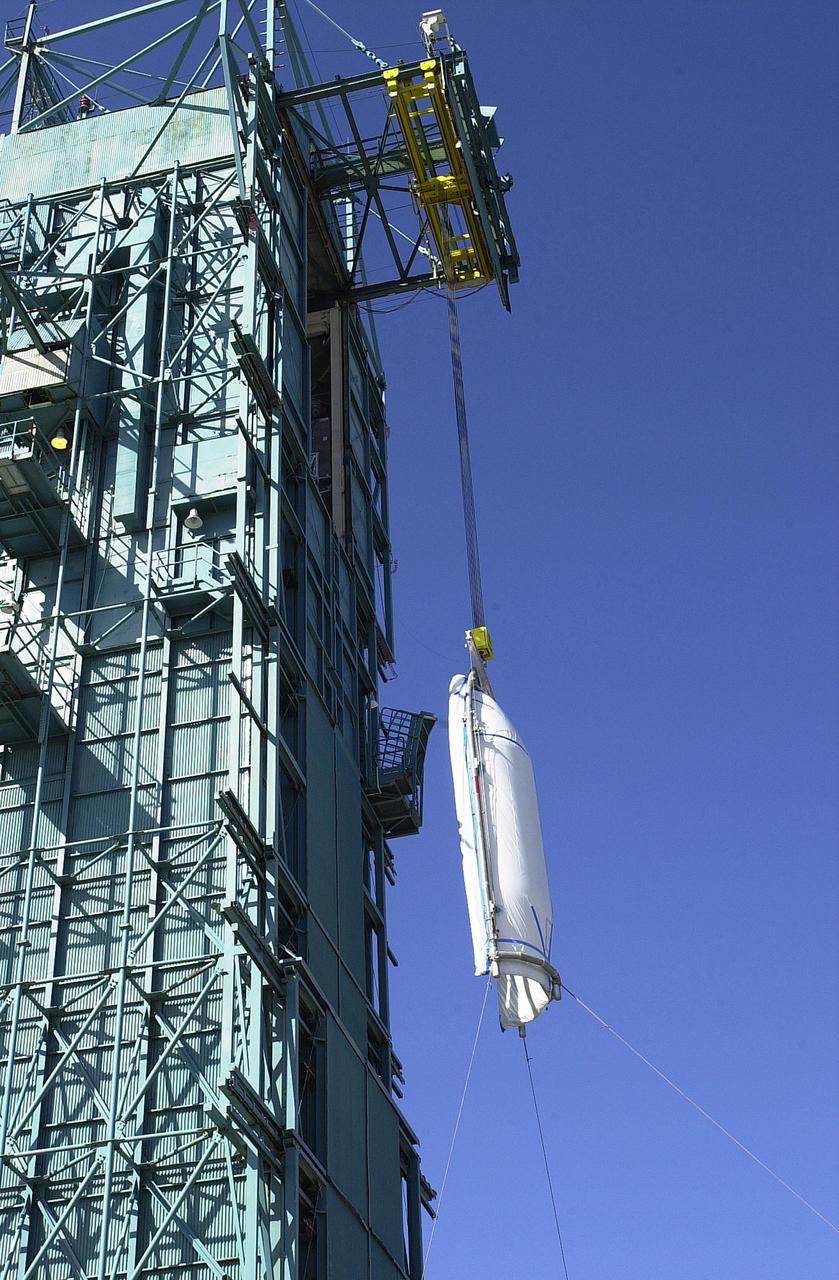 VANDENBERG AIR FORCE BASE, CALIF.   - At NASA Space Launch Complex 2 on Vandenberg Air Force Base in California, one half of the fairing for CALIPSO_CloudSat is being lifted up the mobile service tower, or gantry.  The fairing encloses and protects the spacecraft during launch and flight through the atmosphere. Once in space, it is jettisoned. CALIPSO stands for Cloud-Aerosol Lidar and Infrared Pathfinder Satellite Observation.   CALIPSO and CloudSat are highly complementary satellites and together will provide never-before-seen 3-D perspectives of how clouds and aerosols form, evolve, and affect weather and climate. CALIPSO and CloudSat will fly in formation with three other satellites in the A-train constellation to enhance understanding of our climate system. Launch of CALIPSO_CloudSat aboard a Boeing Delta II rocket is scheduled for 3:01 a.m. Sept. 29.