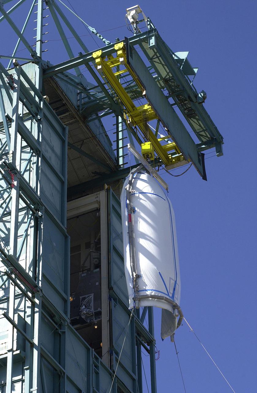 VANDENBERG AIR FORCE BASE, CALIF.  - At NASA Space Launch Complex 2 on Vandenberg Air Force Base in California, the first half of the fairing for CALIPSO_CloudSat reaches the top of the mobile service tower, or gantry.  The fairing encloses and protects the spacecraft during launch and flight through the atmosphere. Once in space, it is jettisoned. CALIPSO stands for Cloud-Aerosol Lidar and Infrared Pathfinder Satellite Observation.   CALIPSO and CloudSat are highly complementary satellites and together will provide never-before-seen 3-D perspectives of how clouds and aerosols form, evolve, and affect weather and climate. CALIPSO and CloudSat will fly in formation with three other satellites in the A-train constellation to enhance understanding of our climate system. Launch of CALIPSO_CloudSat aboard a Boeing Delta II rocket is scheduled for 3:01 a.m. Sept. 29.