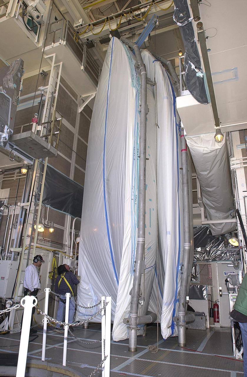 VANDENBERG AIR FORCE BASE, CALIF.  -  In the mobile service tower, or gantry, at NASA Space Launch Complex 2 on Vandenberg Air Force Base in California, the two halves of the fairing are ready to encapsulate CALIPSO_CloudSat for launch. The fairing encloses and protects the spacecraft during launch and flight through the atmosphere. Once in space, it is jettisoned. CALIPSO stands for Cloud-Aerosol Lidar and Infrared Pathfinder Satellite Observation.   CALIPSO and CloudSat are highly complementary satellites and together will provide never-before-seen 3-D perspectives of how clouds and aerosols form, evolve, and affect weather and climate. CALIPSO and CloudSat will fly in formation with three other satellites in the A-train constellation to enhance understanding of our climate system. Launch of CALIPSO_CloudSat aboard a Boeing Delta II rocket is scheduled for 3:01 a.m. Sept. 29.