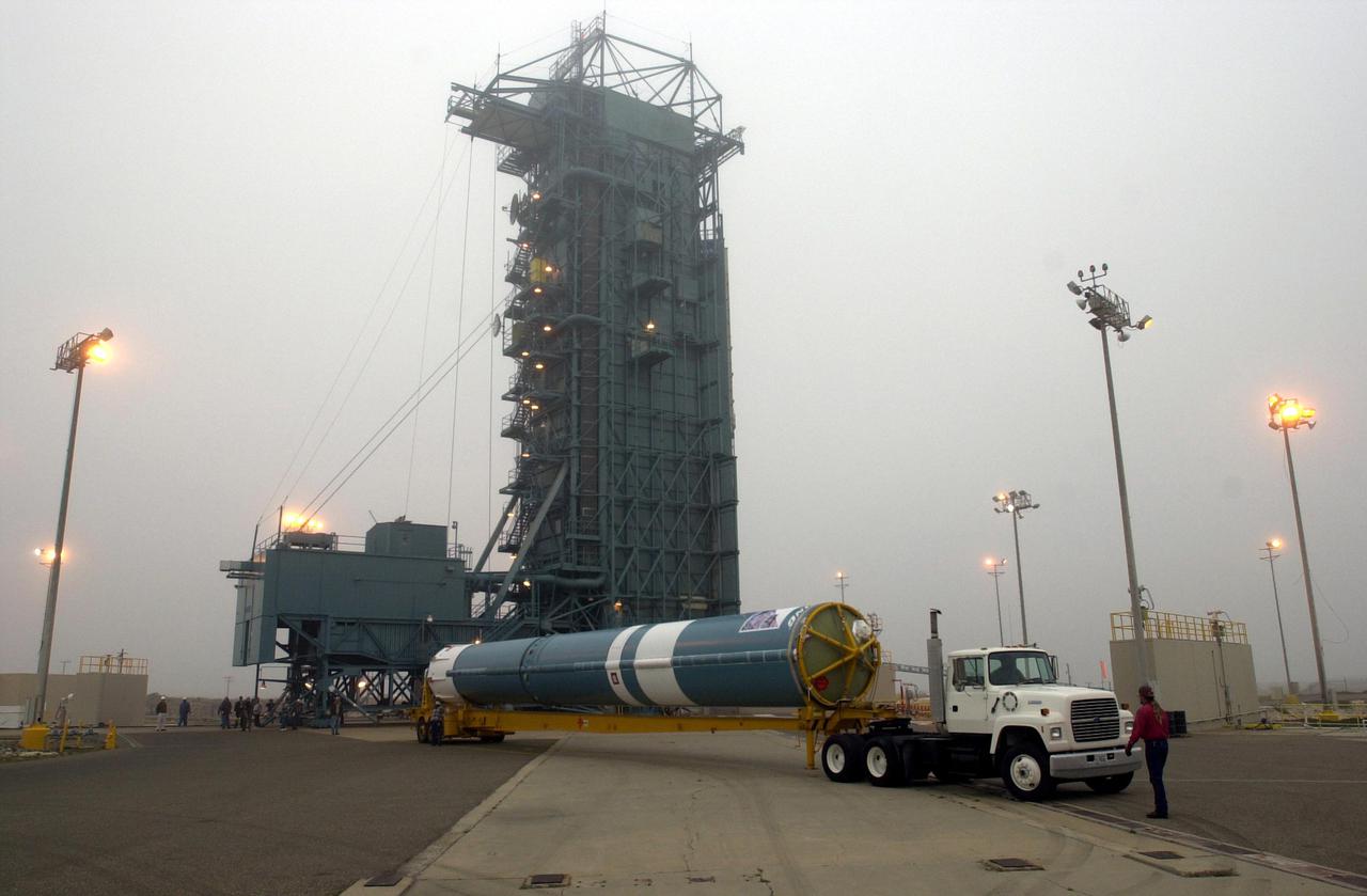 VANDENBERG AIR FORCE BASE, CALIF.   -  At NASA Space Launch Complex 2 on Vandenberg Air Force Base in California, the first stage of the Boeing Delta II rocket for the CALIPSO_CloudSat launch arrives on the pad.  It will be raised to vertical and lifted up into the mobile service tower, or gantry. CALIPSO stands for Cloud-Aerosol Lidar and Infrared Pathfinder Satellite Observation.   CALIPSO and CloudSat are highly complementary satellites and together will provide never-before-seen 3-D perspectives of how clouds and aerosols form, evolve, and affect weather and climate. CALIPSO and CloudSat will fly in formation with three other satellites in the A-train constellation to enhance understanding of our climate system. Launch of CALIPSO_CloudSat aboard a Boeing Delta II rocket is scheduled for 3:01 a.m. Sept. 29.