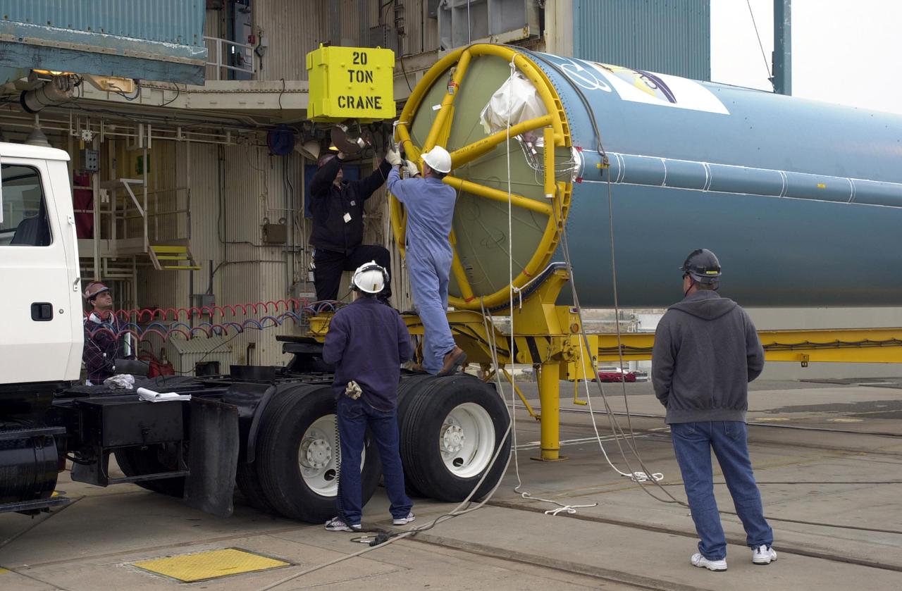 VANDENBERG AIR FORCE BASE, CALIF.  — At NASA Space Launch Complex 2 on Vandenberg Air Force Base in California, workers get ready to raise the first stage of the Boeing Delta II rocket, launch vehicle for the CALIPSO_CloudSat spacecraft.  Once it is vertical, it will be lifted up into the Mobile service tower, or gantry. CALIPSO stands for Cloud-Aerosol Lidar and Infrared Pathfinder Satellite Observation.   CALIPSO and CloudSat are highly complementary satellites and together will provide never-before-seen 3-D perspectives of how clouds and aerosols form, evolve, and affect weather and climate. CALIPSO and CloudSat will fly in formation with three other satellites in the A-train constellation to enhance understanding of our climate system. Launch of CALIPSO_CloudSat aboard a Boeing Delta II rocket is scheduled for 3:01 a.m. Sept. 29.