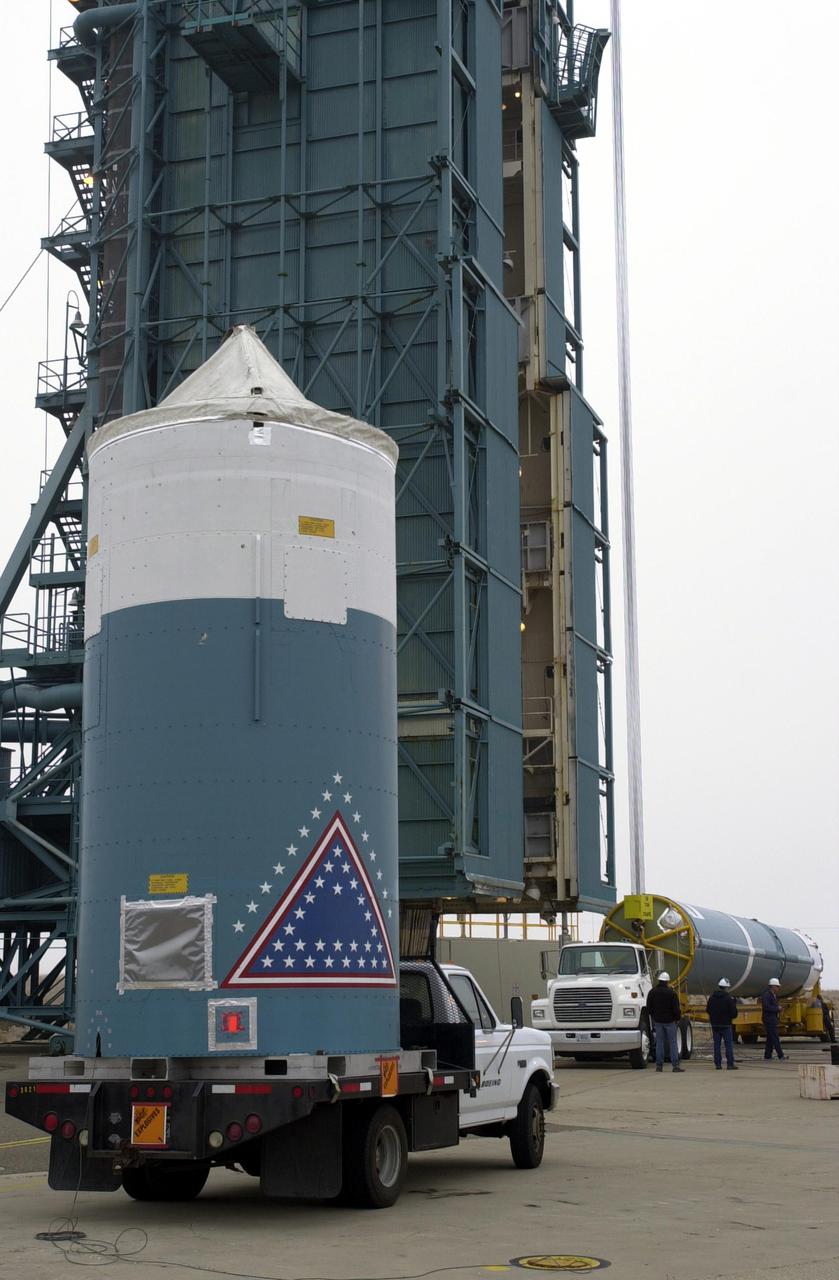 VANDENBERG AIR FORCE BASE, CALIF.  -  At NASA Space Launch Complex 2 on Vandenberg Air Force Base in California, the interstage for the Boeing Delta II rocket, launch vehicle for the CALIPSO_CloudSat spacecraft, arrives at the pad.  It will be lifted up into the mobile service tower, or gantry, and mated with the first stage.  CALIPSO stands for Cloud-Aerosol Lidar and Infrared Pathfinder Satellite Observation.  CALIPSO and CloudSat are highly complementary satellites and together will provide never-before-seen 3-D perspectives of how clouds and aerosols form, evolve, and affect weather and climate. CALIPSO and CloudSat will fly in formation with three other satellites in the A-train constellation to enhance understanding of our climate system. Launch of CALIPSO_CloudSat aboard a Boeing Delta II rocket is scheduled for 3:01 a.m. Sept. 29.