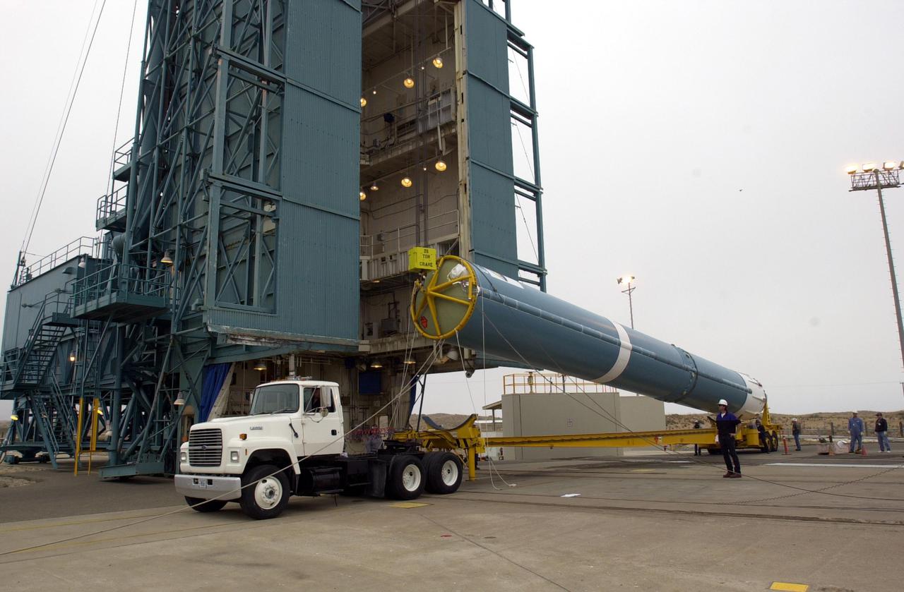 VANDENBERG AIR FORCE BASE, CALIF.  - At NASA Space Launch Complex 2 on Vandenberg Air Force Base in California, the first stage of the Boeing Delta II rocket, launch vehicle for the CALIPSO_CloudSat spacecraft, is raised off the transporter.  Once it is vertical, it will be lifted up into the mobile service tower, or gantry. CALIPSO stands for Cloud-Aerosol Lidar and Infrared Pathfinder Satellite Observation.  CALIPSO and CloudSat are highly complementary satellites and together will provide never-before-seen 3-D perspectives of how clouds and aerosols form, evolve, and affect weather and climate. CALIPSO and CloudSat will fly in formation with three other satellites in the A-train constellation to enhance understanding of our climate system. Launch of CALIPSO_CloudSat aboard a Boeing Delta II rocket is scheduled for 3:01 a.m. Sept. 29.