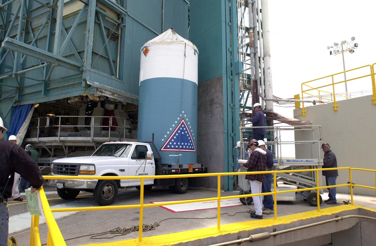 VANDENBERG AIR FORCE BASE, CALIF.  - At NASA Space Launch Complex 2 on Vandenberg Air Force Base in California, the interstage for the Boeing Delta II rocket arrives on the pad.  It will be lifted up the mobile service tower, or gantry, and mated with the first stage already there. The Delta is the launch vehicle for the CALIPSO_CloudSat spacecraft. CALIPSO stands for Cloud-Aerosol Lidar and Infrared Pathfinder Satellite Observation.  CALIPSO and CloudSat are highly complementary satellites and together will provide never-before-seen 3-D perspectives of how clouds and aerosols form, evolve, and affect weather and climate. CALIPSO and CloudSat will fly in formation with three other satellites in the A-train constellation to enhance understanding of our climate system. Launch of CALIPSO_CloudSat aboard a Boeing Delta II rocket is scheduled for 3:01 a.m. Sept. 29.
