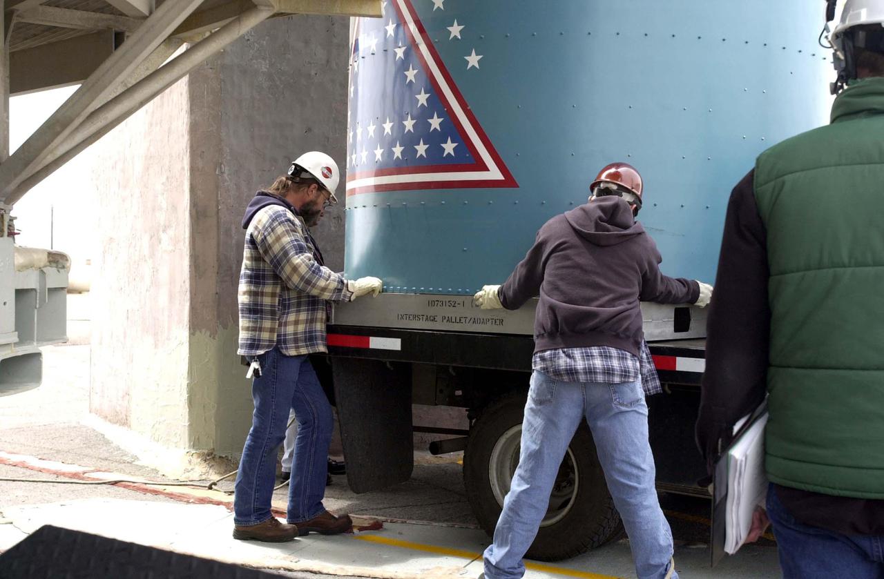 VANDENBERG AIR FORCE BASE, CALIF.  - At NASA Space Launch Complex 2 on Vandenberg Air Force Base in California, workers prepare the interstage for the Boeing Delta II rocket to be lifted up the mobile service tower, or gantry.  Then it will be mated with the first stage already there.  The Delta is the launch vehicle for the CALIPSO_CloudSat spacecraft. CALIPSO stands for Cloud-Aerosol Lidar and Infrared Pathfinder Satellite Observation.  CALIPSO and CloudSat are highly complementary satellites and together will provide never-before-seen 3-D perspectives of how clouds and aerosols form, evolve, and affect weather and climate. CALIPSO and CloudSat will fly in formation with three other satellites in the A-train constellation to enhance understanding of our climate system. Launch of CALIPSO_CloudSat aboard a Boeing Delta II rocket is scheduled for 3:01 a.m. Sept. 29.