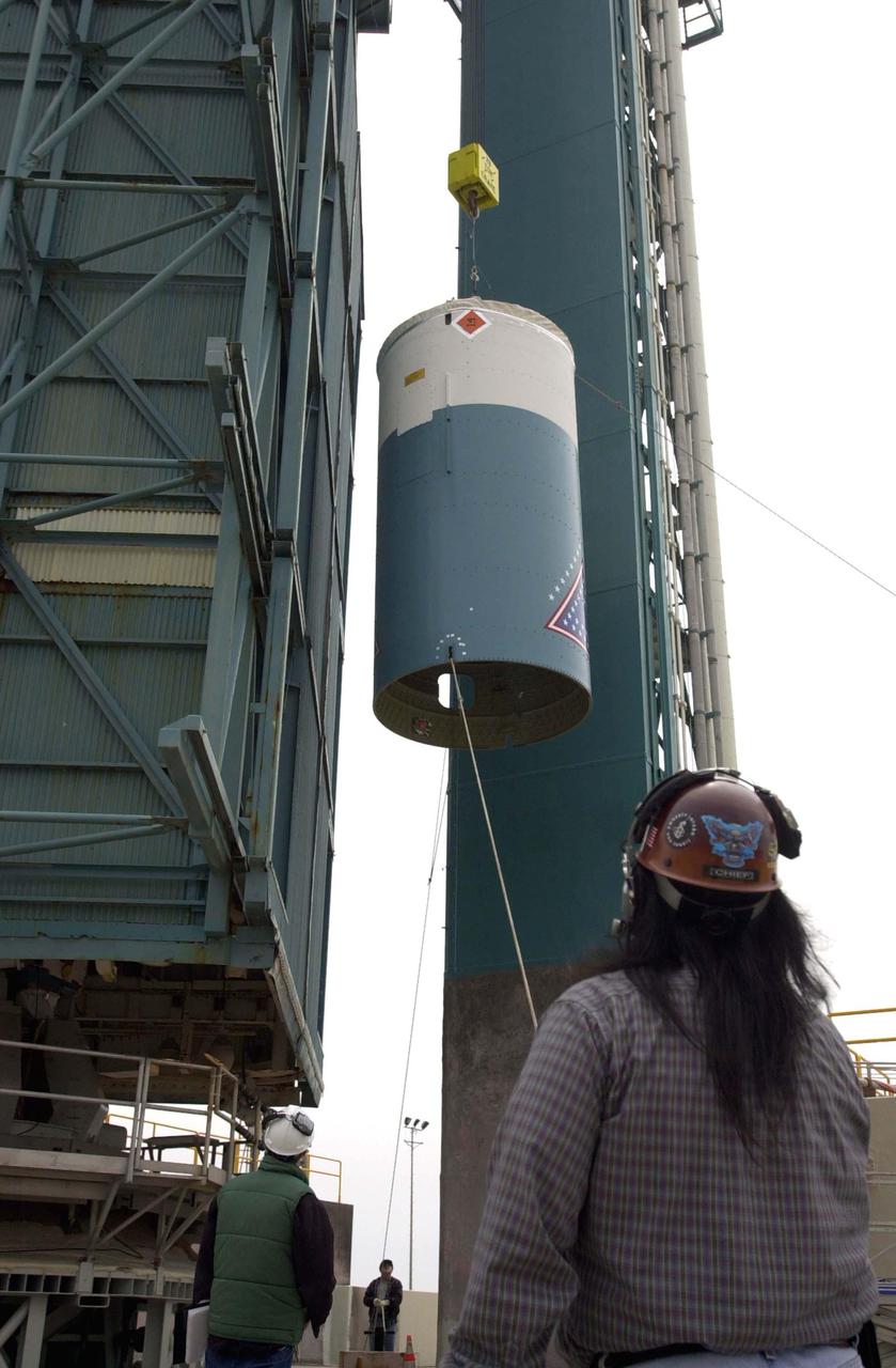 VANDENBERG AIR FORCE BASE, CALIF.  - At NASA Space Launch Complex 2 on Vandenberg Air Force Base in California, the interstage for the Boeing Delta II rocket is lifted up the mobile service tower, or gantry.  There it will be mated with the first stage already there.  The Delta is the launch vehicle for the CALIPSO_CloudSat spacecraft.  CALIPSO stands for Cloud-Aerosol Lidar and Infrared Pathfinder Satellite Observation.  CALIPSO and CloudSat are highly complementary satellites and together will provide never-before-seen 3-D perspectives of how clouds and aerosols form, evolve, and affect weather and climate. CALIPSO and CloudSat will fly in formation with three other satellites in the A-train constellation to enhance understanding of our climate system. Launch of CALIPSO_CloudSat aboard a Boeing Delta II rocket is scheduled for 3:01 a.m. Sept. 29.