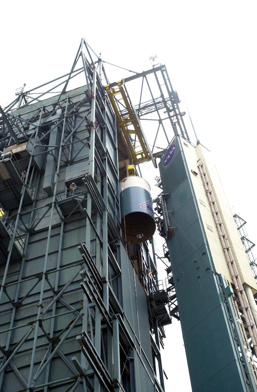 VANDENBERG AIR FORCE BASE, CALIF.  - At NASA Space Launch Complex 2 on Vandenberg Air Force Base in California, the interstage for the Boeing Delta II rocket nears the top of the mobile service tower, or gantry.  There it will be mated with the first stage already there.  The Delta is the launch vehicle for the CALIPSO_CloudSat spacecraft.  CALIPSO stands for Cloud-Aerosol Lidar and Infrared Pathfinder Satellite Observation.  CALIPSO and CloudSat are highly complementary satellites and together will provide never-before-seen 3-D perspectives of how clouds and aerosols form, evolve, and affect weather and climate. CALIPSO and CloudSat will fly in formation with three other satellites in the A-train constellation to enhance understanding of our climate system. Launch of CALIPSO_CloudSat aboard a Boeing Delta II rocket is scheduled for 3:01 a.m. Sept. 29.