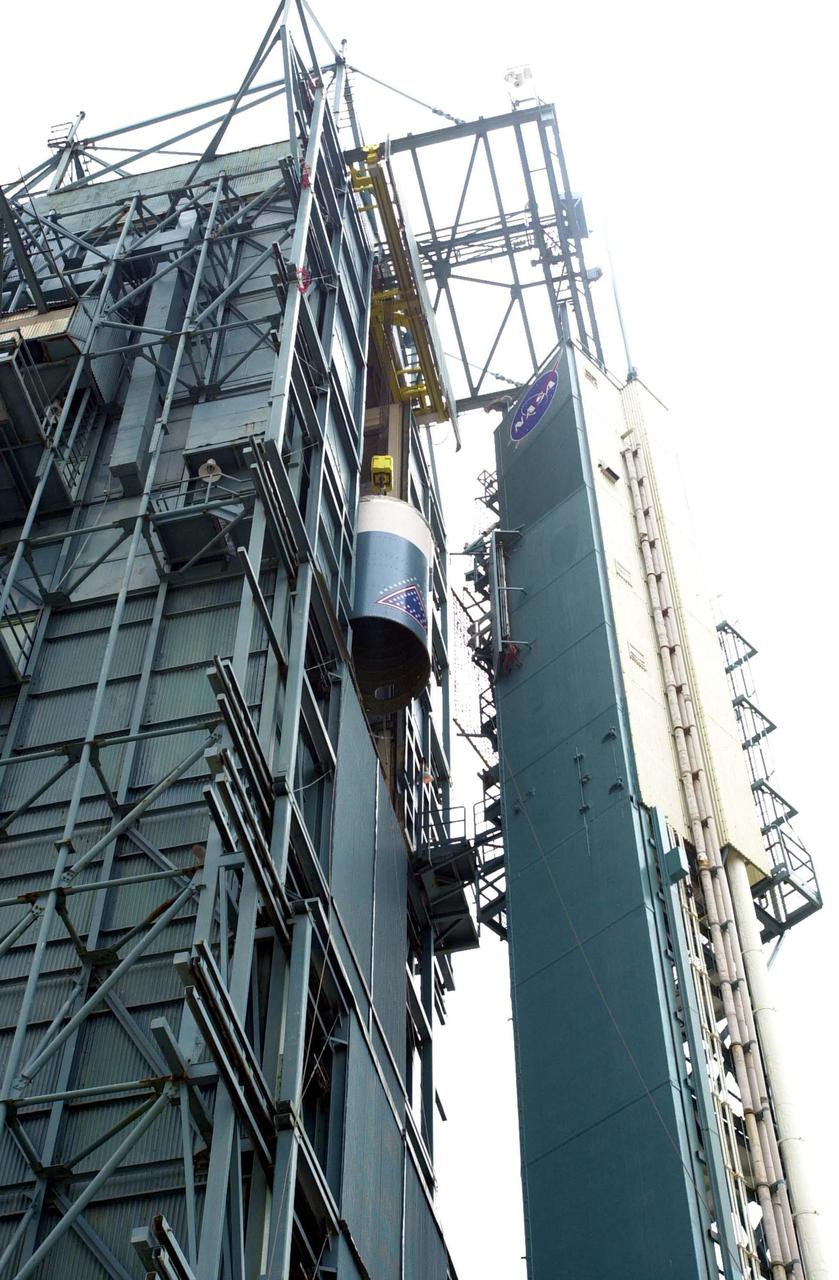 VANDENBERG AIR FORCE BASE, CALIF.  - At NASA Space Launch Complex 2 on Vandenberg Air Force Base in California, the interstage for the Boeing Delta II rocket nears the top of the mobile service tower, or gantry.  There it will be mated with the first stage already there.  The Delta is the launch vehicle for the CALIPSO_CloudSat spacecraft.  CALIPSO stands for Cloud-Aerosol Lidar and Infrared Pathfinder Satellite Observation.  CALIPSO and CloudSat are highly complementary satellites and together will provide never-before-seen 3-D perspectives of how clouds and aerosols form, evolve, and affect weather and climate. CALIPSO and CloudSat will fly in formation with three other satellites in the A-train constellation to enhance understanding of our climate system. Launch of CALIPSO_CloudSat aboard a Boeing Delta II rocket is scheduled for 3:01 a.m. Sept. 29.