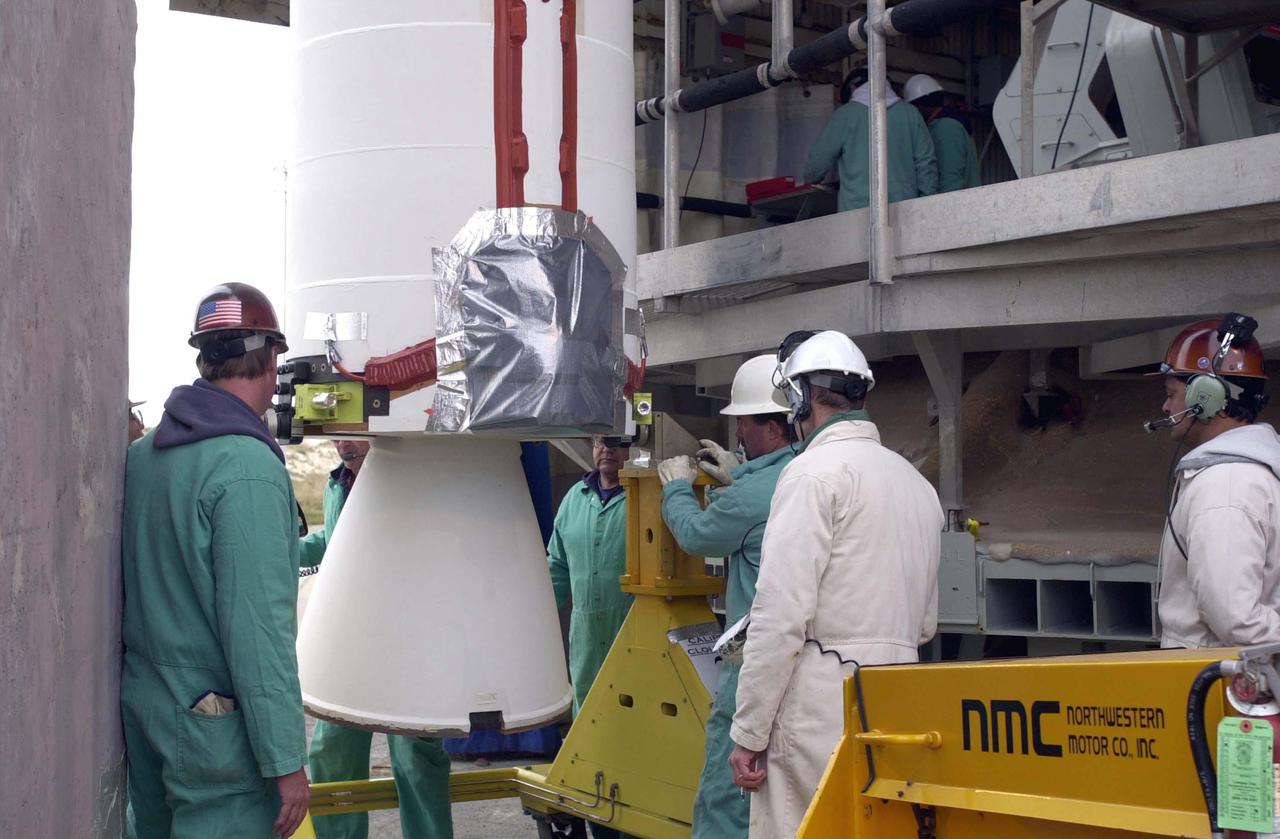 VANDENBERG AIR FORCE BASE, CALIF.  - Workers on NASA Space Launch Complex 2 at Vandenberg Air Force Base in California prepare the Solid Rocket Booster for lifting into the mobile service tower, or gantry, where it will be attached to the Boeing Delta II rocket.  The Delta is the launch vehicle for the CALIPSO_CloudSat spacecraft. CALIPSO stands for Cloud-Aerosol Lidar and Infrared Pathfinder Satellite Observation.  CALIPSO and CloudSat are highly complementary satellites and together will provide never-before-seen 3-D perspectives of how clouds and aerosols form, evolve, and affect weather and climate. CALIPSO and CloudSat will fly in formation with three other satellites in the A-train constellation to enhance understanding of our climate system. Launch of CALIPSO_CloudSat aboard a Boeing Delta II rocket is scheduled for 3:01 a.m. Sept. 29.