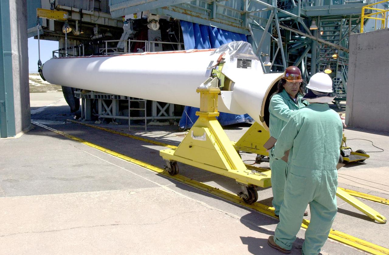VANDENBERG AIR FORCE BASE, CALIF.  - At NASA Space Launch Complex 2 on Vandenberg Air Force Base in California, workers prepare a Solid Rocket Booster to be raised to a vertical position.  It will then be lifted into the mobile service tower, or gantry, and attached to the Boeing Delta II rocket. The Delta is the launch vehicle for the CALIPSO_CloudSat spacecraft. CALIPSO stands for Cloud-Aerosol Lidar and Infrared Pathfinder Satellite Observation.  CALIPSO and CloudSat are highly complementary satellites and together will provide never-before-seen 3-D perspectives of how clouds and aerosols form, evolve, and affect weather and climate. CALIPSO and CloudSat will fly in formation with three other satellites in the A-train constellation to enhance understanding of our climate system. Launch of CALIPSO_CloudSat aboard a Boeing Delta II rocket is scheduled for 3:01 a.m. Sept. 29.