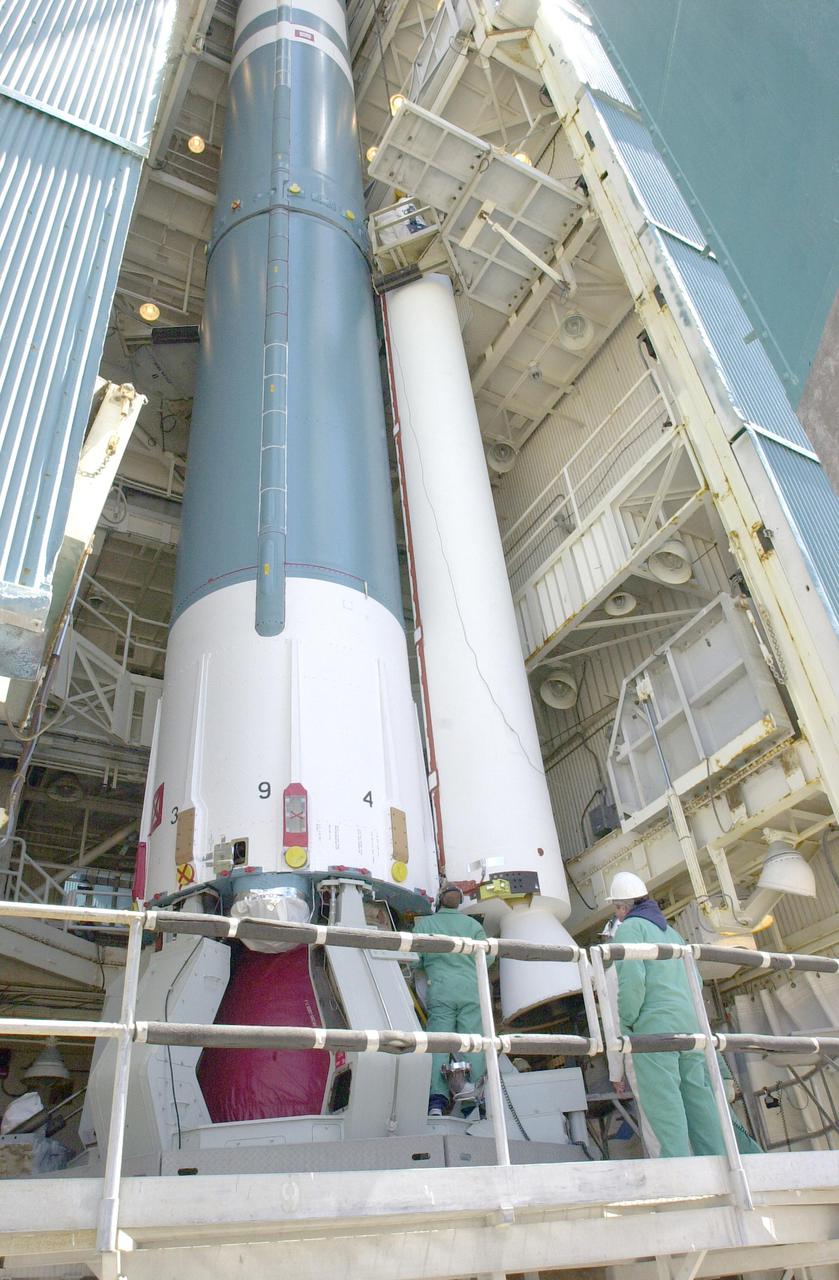 VANDENBERG AIR FORCE BASE, CALIF.  -  At NASA Space Launch Complex 2 on Vandenberg Air Force Base in California, another Solid Rocket Booster is attached to the Boeing Delta II rocket seen behind it.   The Delta is the launch vehicle for the CALIPSO_CloudSat spacecraft. CALIPSO stands for Cloud-Aerosol Lidar and Infrared Pathfinder Satellite Observation.  CALIPSO and CloudSat are highly complementary satellites and together will provide never-before-seen 3-D perspectives of how clouds and aerosols form, evolve, and affect weather and climate. CALIPSO and CloudSat will fly in formation with three other satellites in the A-train constellation to enhance understanding of our climate system. Launch of CALIPSO_CloudSat aboard a Boeing Delta II rocket is scheduled for 3:01 a.m. Sept. 29.