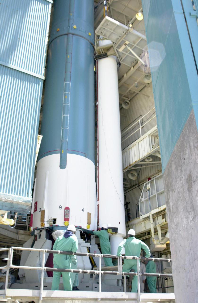 VANDENBERG AIR FORCE BASE, CALIF.  - At NASA Space Launch Complex 2 on Vandenberg Air Force Base in California, another Solid Rocket Booster is attached to the Boeing Delta II rocket seen behind it.   The Delta is the launch vehicle for the CALIPSO_CloudSat spacecraft.  CALIPSO stands for Cloud-Aerosol Lidar and Infrared Pathfinder Satellite Observation.  CALIPSO and CloudSat are highly complementary satellites and together will provide never-before-seen 3-D perspectives of how clouds and aerosols form, evolve, and affect weather and climate. CALIPSO and CloudSat will fly in formation with three other satellites in the A-train constellation to enhance understanding of our climate system. Launch of CALIPSO_CloudSat aboard a Boeing Delta II rocket is scheduled for 3:01 a.m. Sept. 29.