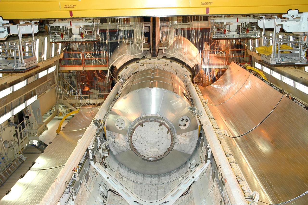 KENNEDY SPACE CENTER, FLA.  -  In bay 3 of NASA Kennedy Space Center’s Orbiter Processing Facility, the payload bay doors on Discovery are open.  Seen inside is the Multi-Purpose Logistics Module Raffaello, which holds material being returned to KSC from the International Space Station as part of Return to Flight mission STS-114.  The module will be lifted out of the payload bay and transferred to the Space Station Processing Facility to be emptied. Discovery will begin processing for the second Return to Flight mission, STS-121.