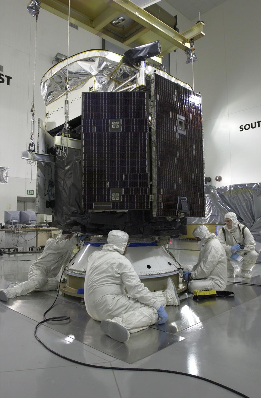 KENNEDY SPACE CENTER, FLA. -- Technicians secure NASA's CloudSat spacecraft to a Delta payload attach fitting in a clean room at Vandenberg Air Force Base, Calif.  CALIPSO stands for Cloud-Aerosol Lidar and Infrared Pathfinder Satellite Observation. CALIPSO and CloudSat are highly complementary satellites and will be launched together. They will provide never-before-seen 3-D perspectives of how clouds and aerosols form, evolve, and affect weather and climate. CALIPSO and CloudSat will fly in formation with three other satellites in the A-train constellation to enhance understanding of our climate system. Launch of CALIPSO_CloudSat aboard a Boeing Delta II rocket is scheduled for 3:01 a.m. PDT Sept. 29.