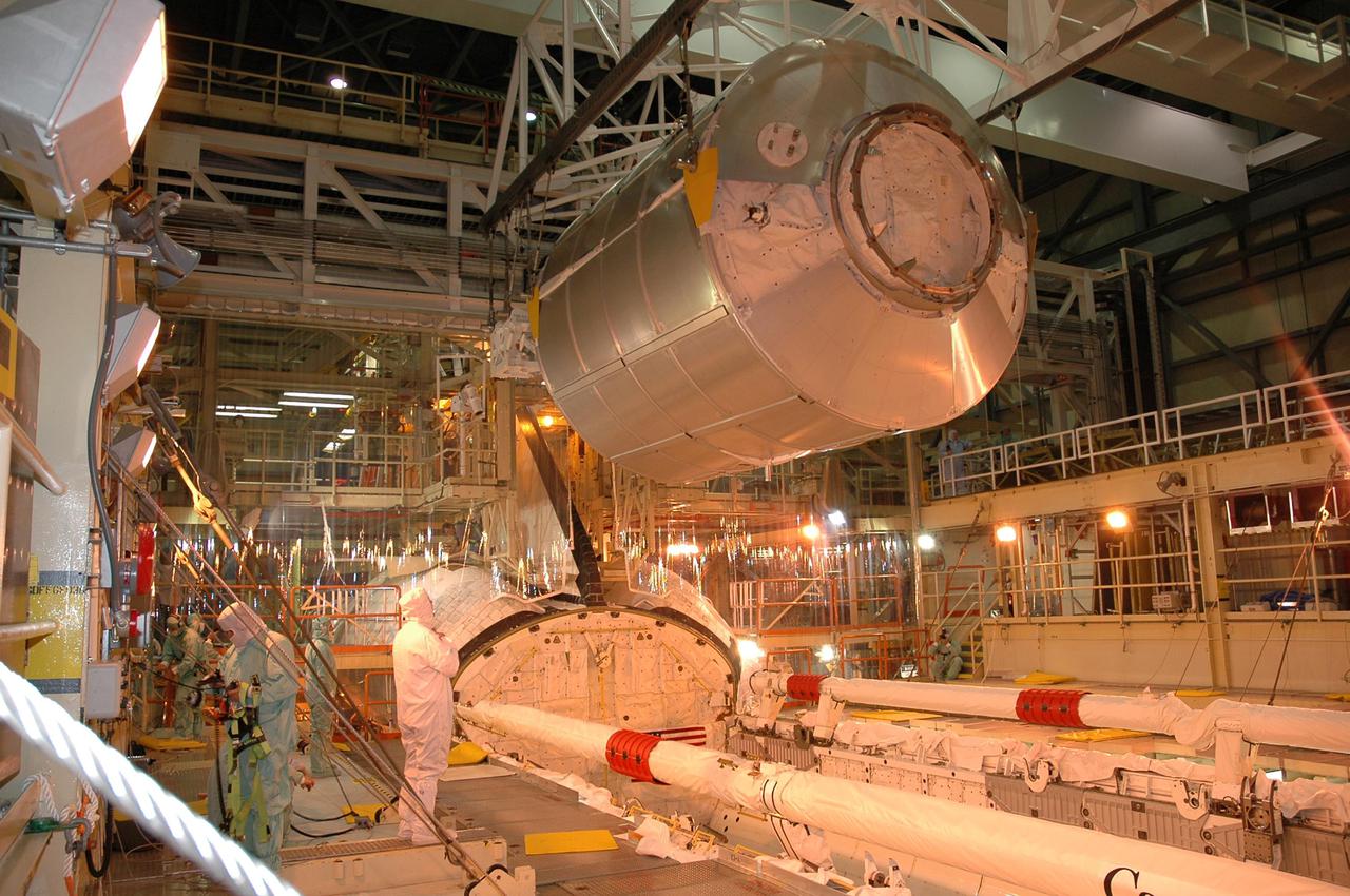 KENNEDY SPACE CENTER, FLA. -- In bay 3 of NASA Kennedy Space Center’s Orbiter Processing Facility, the Multi-Purpose Logistics Module Raffaello is removed from Space Shuttle Discovery's payload bay.  The module holds material returned to KSC from the International Space Station on Return to Flight mission STS-114. The module is being lifted out of the payload bay and transferred to the Space Station Processing Facility to be emptied. Discovery will fly next on the second Return to Flight mission, STS-121.