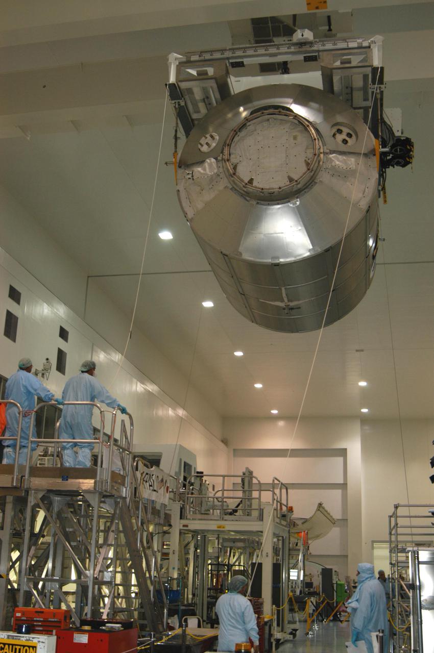 KENNEDY SPACE CENTER, FLA. -- In the Space Station Processing Facility, the suspended Multi-Purpose Logistics Module Raffaello glides above the floor to a work stand at left.  The module will be emptied of its contents, returned from the International Space Station on mission STS-114.  During the Return to Flight mission STS-114, the crews of Discovery and Expedition 11 transferred more than a ton of material from the ISS to be returned to Earth.