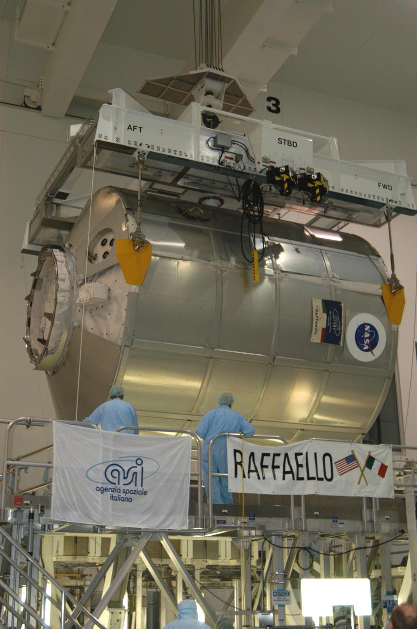 KENNEDY SPACE CENTER, FLA. -- In the Space Station Processing Facility, the suspended Multi-Purpose Logistics Module Raffaello is lowered onto a work stand.  The module will be emptied of its contents, returned from the International Space Station on mission STS-114.  During the Return to Flight mission STS-114, the crews of Discovery and Expedition 11 transferred more than a ton of material from the ISS to be returned to Earth.