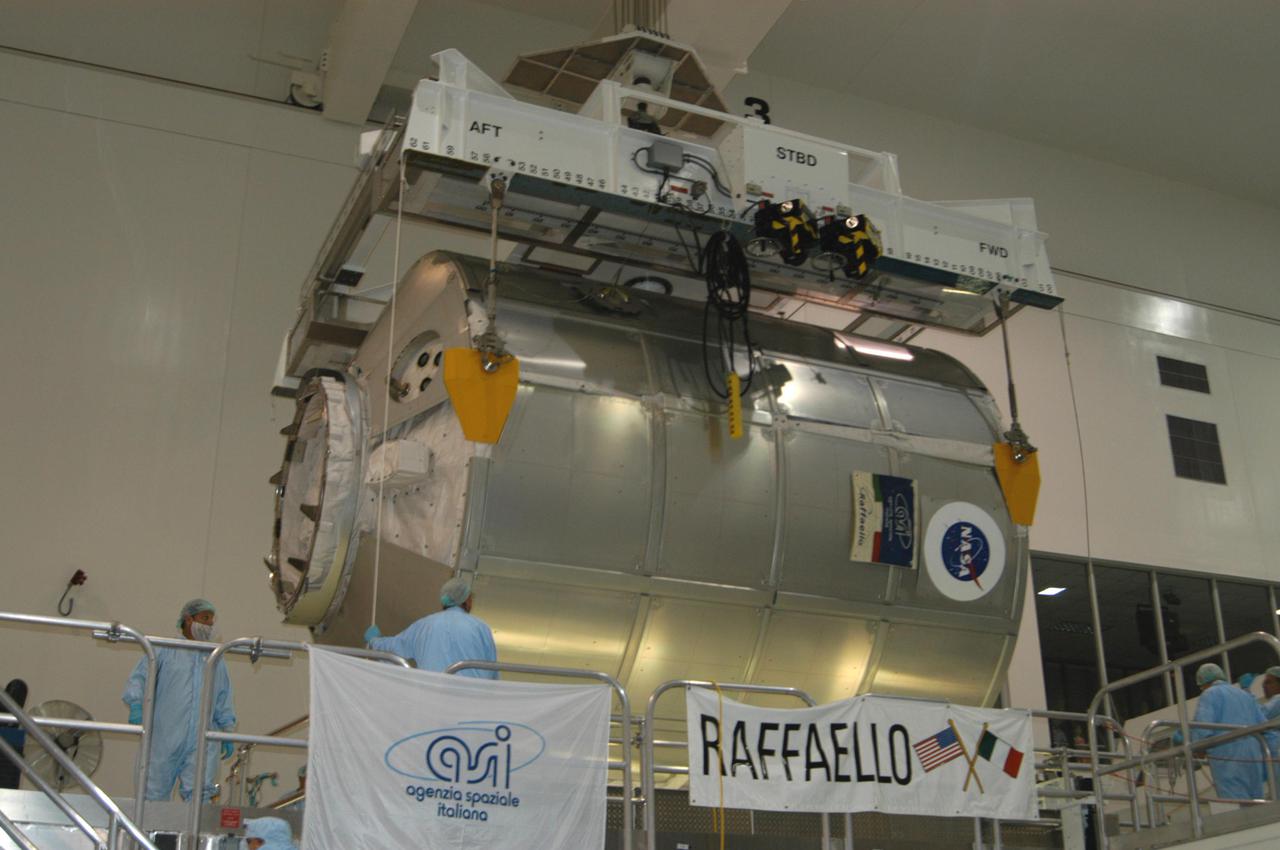 KENNEDY SPACE CENTER, FLA. --In the Space Station Processing Facility, the suspended Multi-Purpose Logistics Module Raffaello is lowered onto a work stand.  The module will be emptied of its contents, returned from the International Space Station on mission STS-114. During the Return to Flight mission STS-114, the crews of Discovery and Expedition 11 transferred more than a ton of material from the ISS to be returned to Earth.